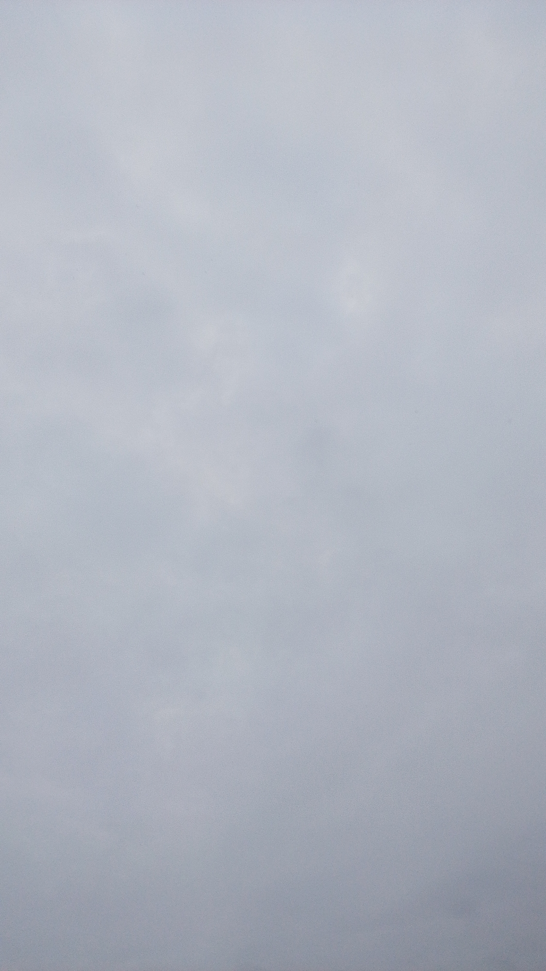 The image shows a uniform, overcast sky with subtle variations in tone. There are no discernible objects, people, or actions visible in the frame. The scene appears to be an outdoor environment, but without any distinguishing features, a specific location within Balewa, Nigeria, or any other city, cannot be determined.