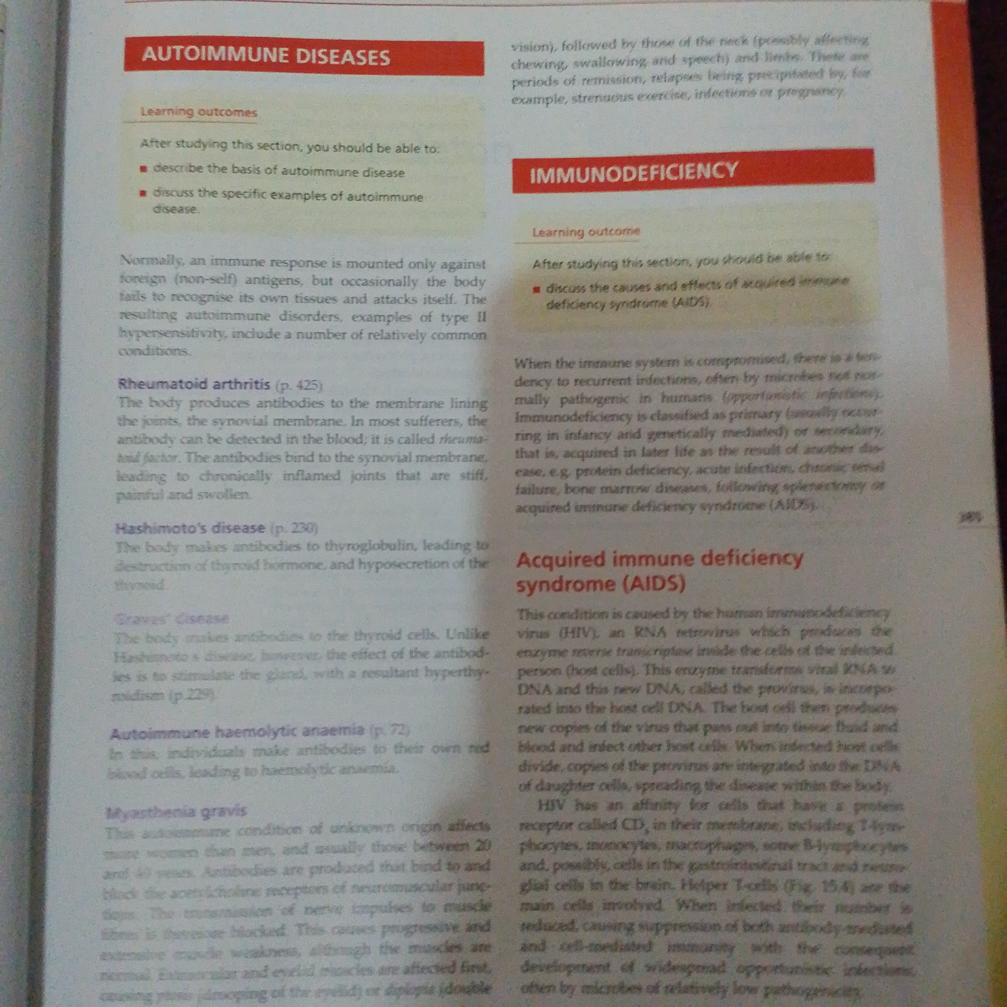 This image is a close-up, overhead shot of an open textbook. The left side of the page features a red header with white text reading "AUTOIMMUNE DISEASES." Below this header, a smaller section with a pale yellow background and black text outlines "Learning outcomes" and lists two bullet points. The main body of text on the left describes autoimmune diseases in general and then lists and describes specific examples like "Rheumatoid arthritis," "Hashimoto's disease," "Graves' disease," "Autoimmune haemolytic anaemia," and "Myasthenia gravis."
The right side of the page has a red header with white text reading "IMMUNODEFICIENCY." Below this, a section with a pale yellow background and black text outlines a "Learning outcome" and a bullet point. The main body of text on the right describes how the immune system can be compromised, leading to immunodeficiency. It then specifically discusses "Acquired immune deficiency syndrome (AIDS)" and its cause, the human immunodeficiency virus (HIV).
The image is a photograph of printed text and has no discernible elements related to Jalingo, Nigeria, or any specific physical location.