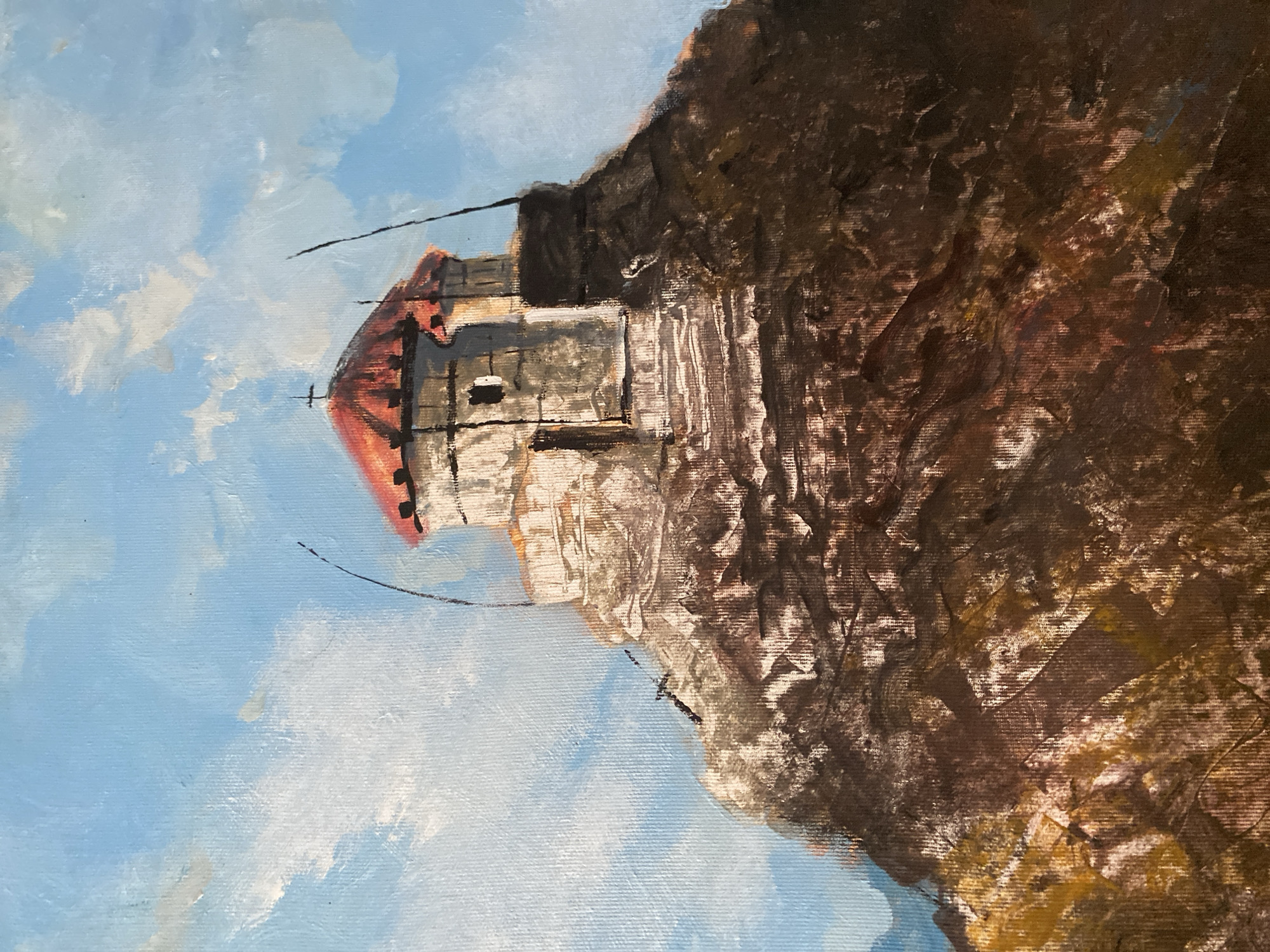 The image is a painting of the fortress of Haj-Nehaj in Sutomore, Montenegro. The fortress is situated on a rocky peak, with a red-tiled roof and a cross atop its dome. The sky above is a clear blue with scattered white clouds. The rocky terrain is depicted in various shades of brown and yellow, suggesting a rugged and arid landscape. The painting style is impressionistic, with visible brushstrokes and a focus on capturing the light and texture of the scene.