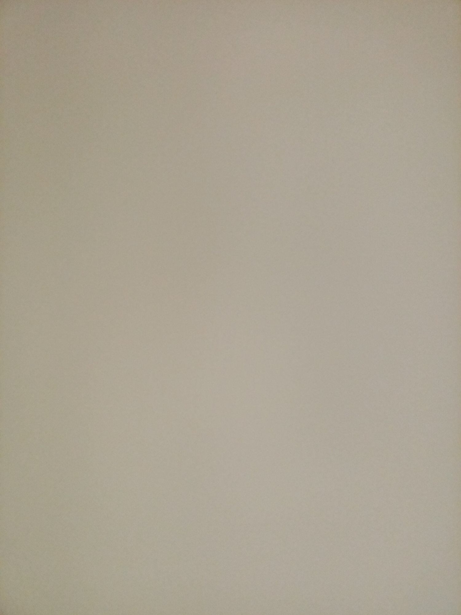 The image is a plain, featureless surface with a light beige or tan color. There are no discernible objects, people, or environmental elements present. The texture appears smooth and uniform, with no shadows or highlights to indicate a specific light source or depth. It is impossible to determine the location, time, or any other contextual information from this image alone.