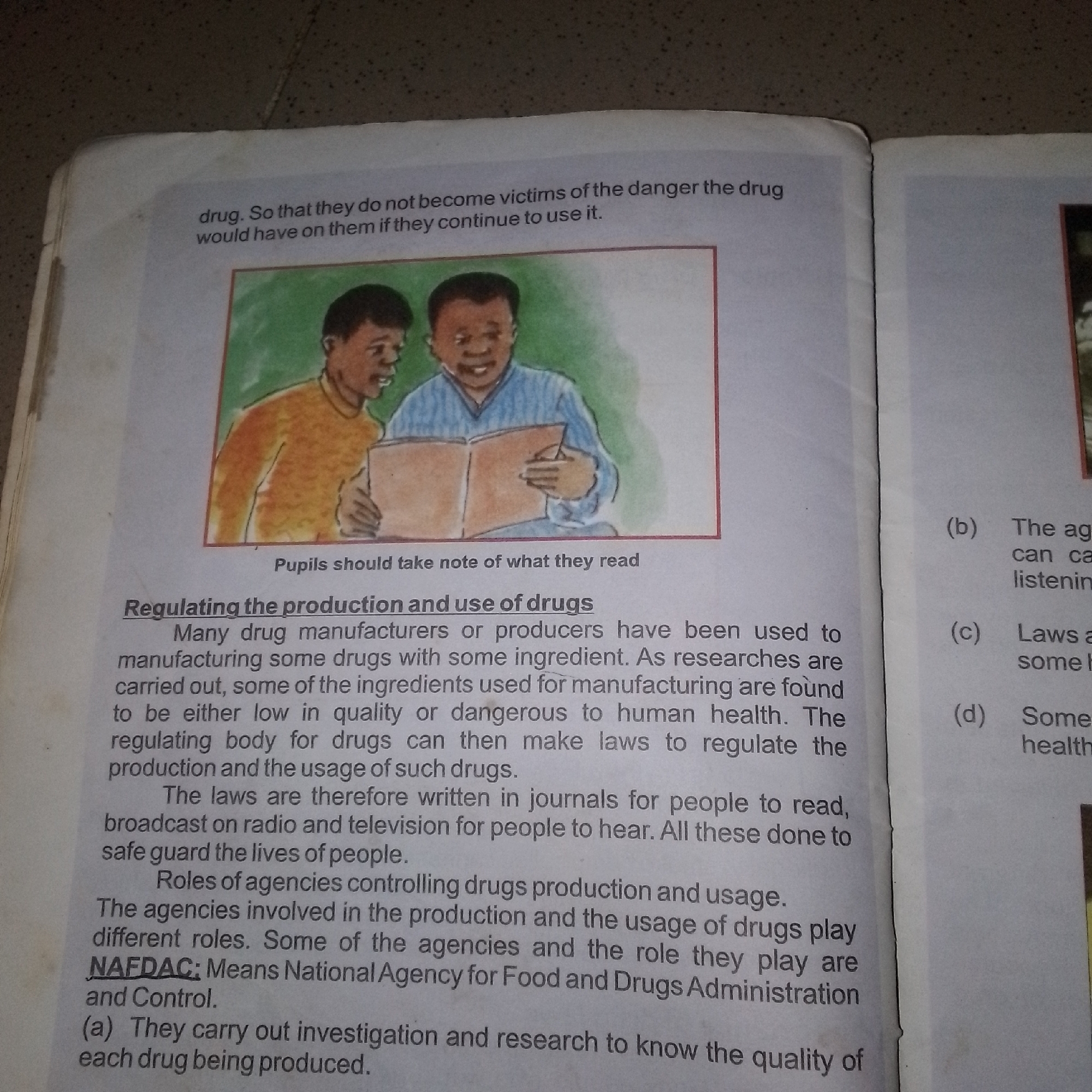 The image displays an open book with text and an illustration. The text on the left page discusses the regulation of drug production and use, mentioning NAFDAC (National Agency for Food and Drugs Administration and Control) and its role in investigating drug quality. The illustration on the left page depicts two individuals, possibly students, looking at a book. The right page contains a list of numbered points (b, c, d) with short phrases, which appear to be related to the text on the left. The book is placed on a textured surface, possibly a floor or a table, with a mottled grey and brown pattern, suggesting an indoor environment. There is no indication or information within the image that connects it to Jalingo, Nigeria.