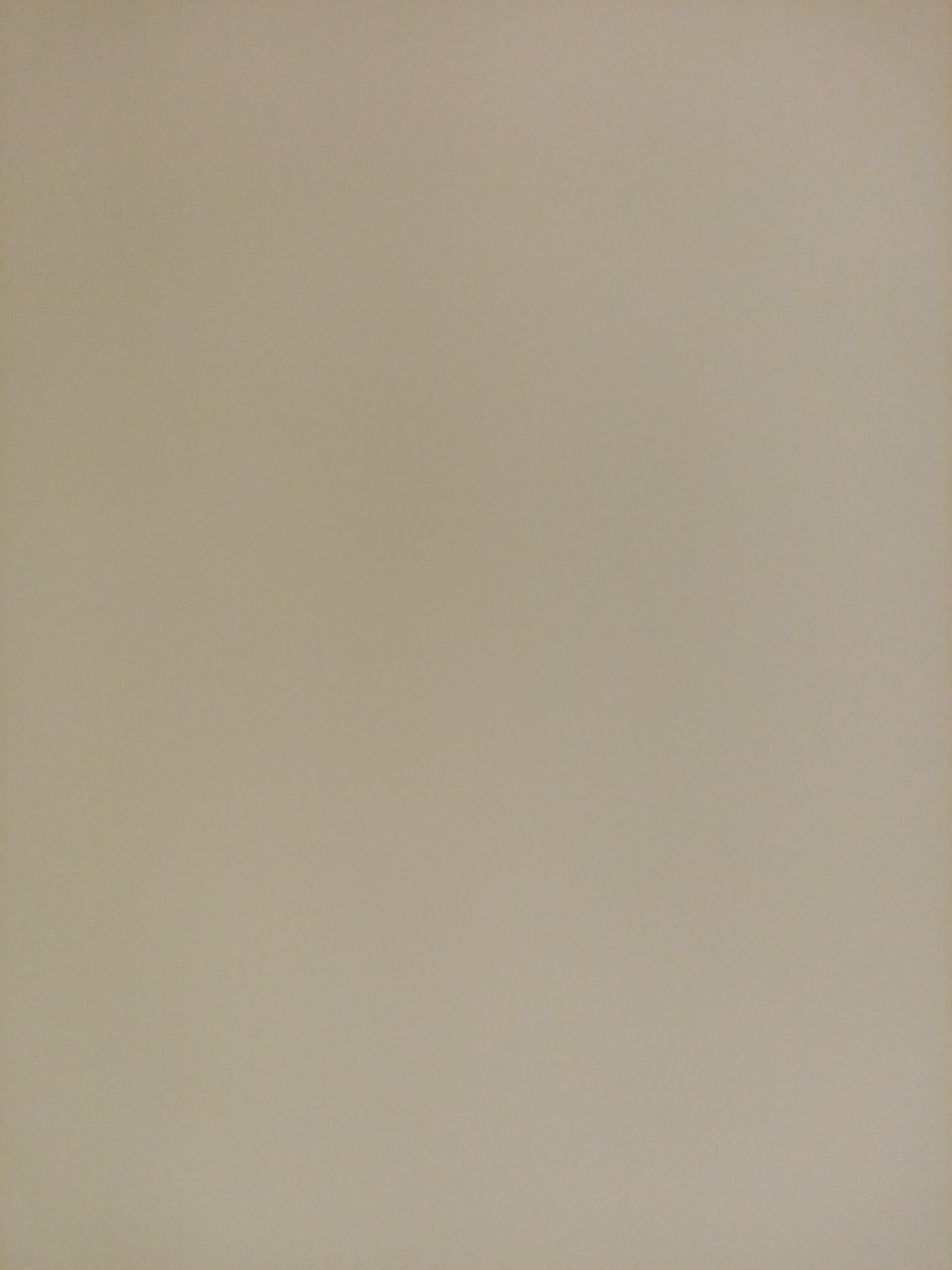 The image is a full frame, close-up, eye-level, static shot of a plain, light beige surface with a subtle texture. There are no discernible objects, people, or environmental features present. The lighting appears to be even, with no strong shadows. The color palette consists solely of variations of beige. The image does not depict any recognizable landmarks or scenes from Rostov-on-Don, Russia.