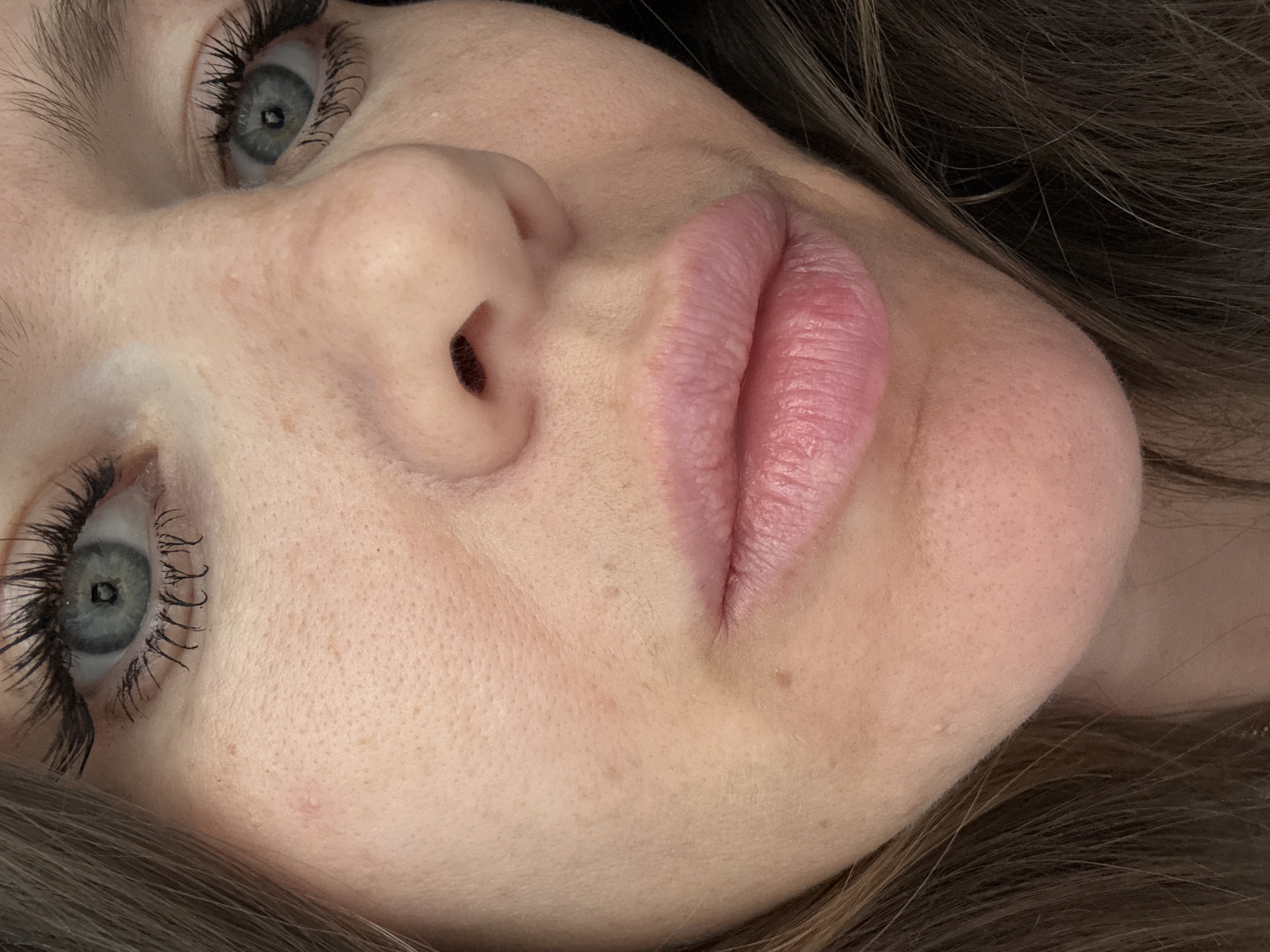 A close-up image features the face of a fair-skinned individual with brown hair. The focal point includes the individual's blue eyes, full lips, and nose. There is no information that suggests the image was taken in Khimki, Russia.
