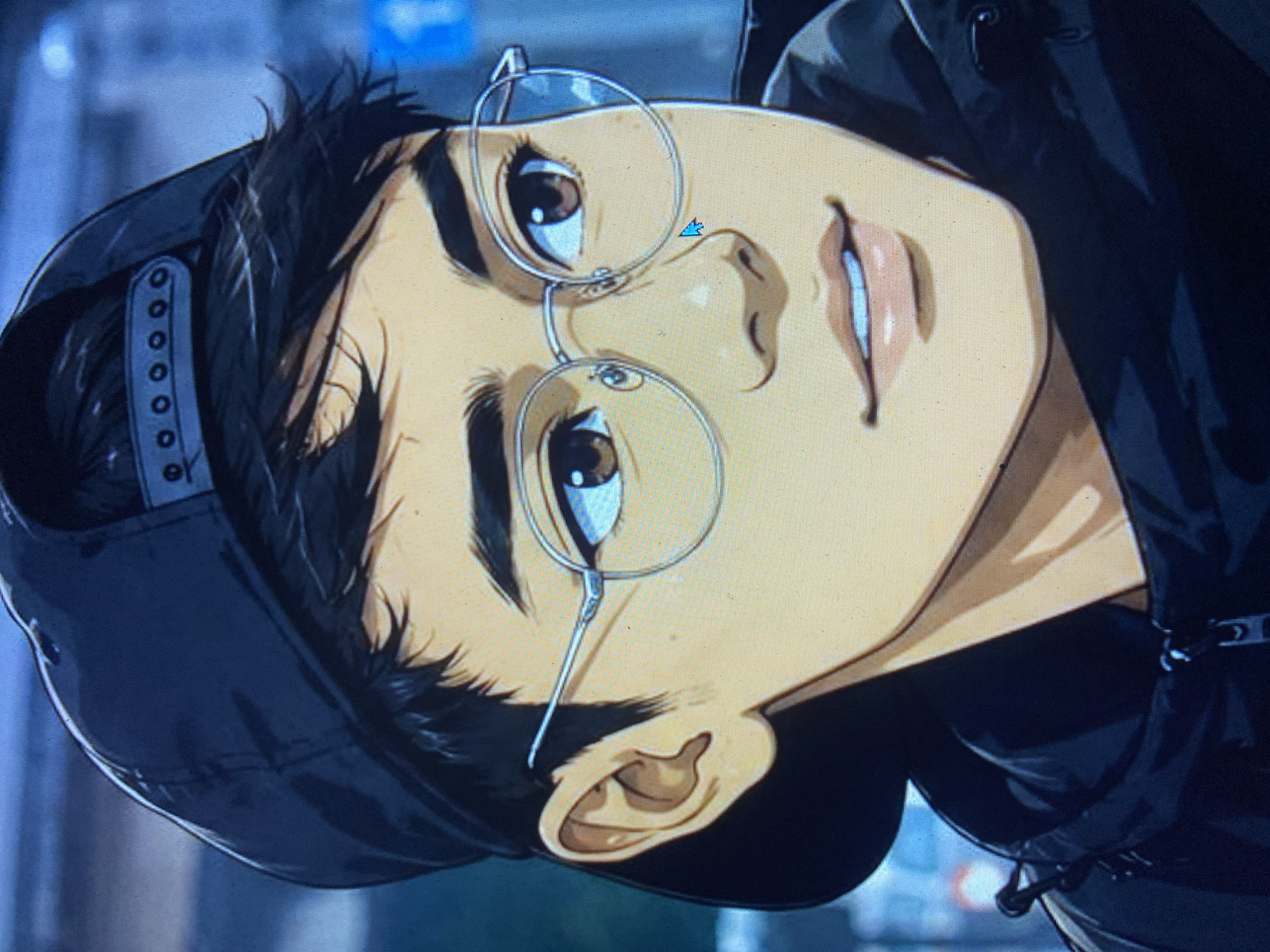The image is a close-up, digitally rendered portrait of a young East Asian male wearing a black baseball cap and round-rimmed glasses. He has dark, tousled hair peeking out from under the cap, prominent eyebrows, and brown eyes. His nose is small and upturned, and his lips are slightly parted, revealing a hint of teeth. He is wearing a dark hooded jacket, visible around his neck and shoulders. The background is a blurred depiction of an urban environment with hints of streetlights and traffic signals, suggesting a nighttime setting. There is a blue cursor visible on his cheek, indicating the image is being viewed on a computer screen. The image does not contain any elements that would place it in Girijaya, Indonesia.