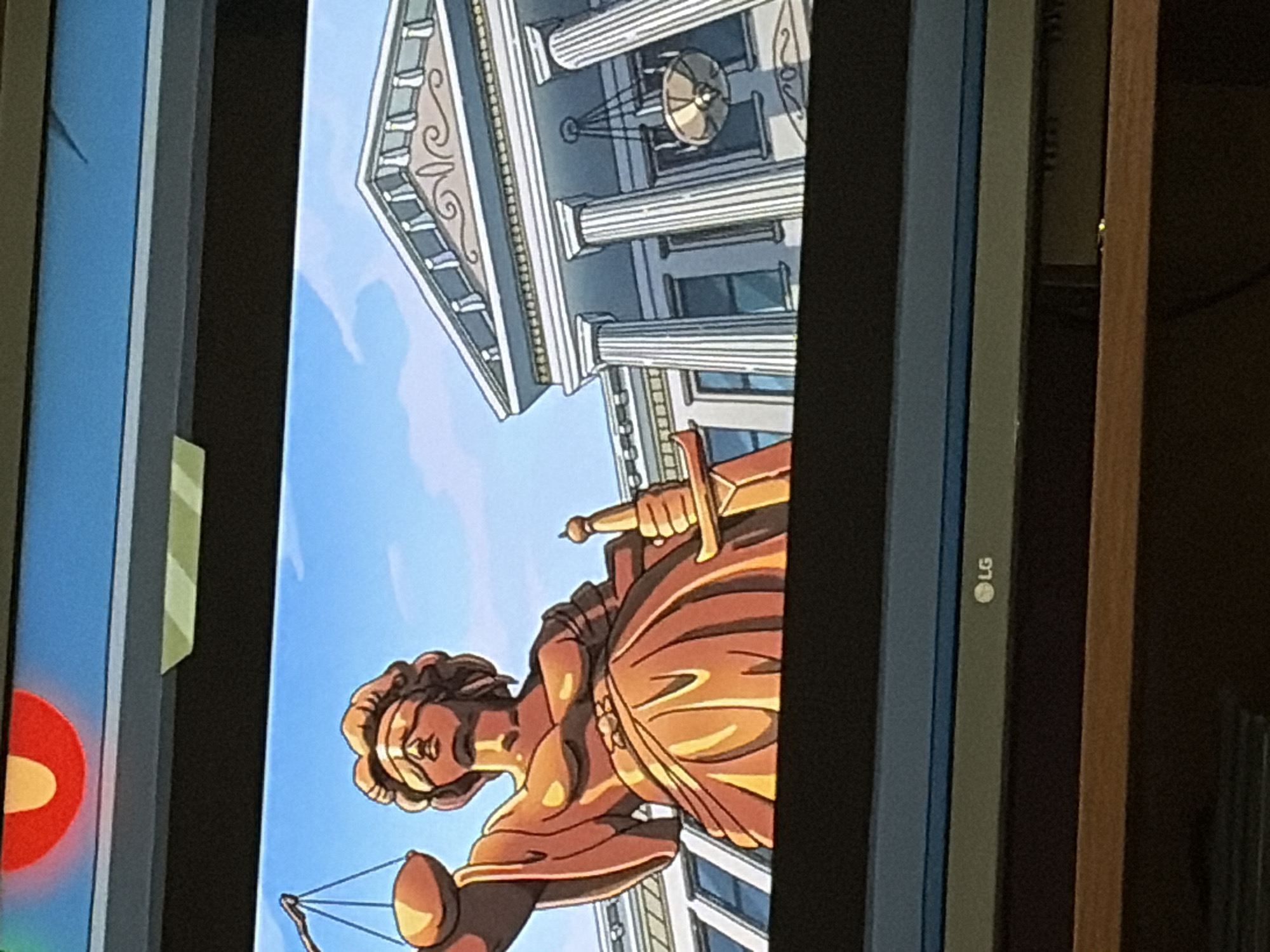 An animated depiction of Lady Justice stands in front of a classical building with large columns and a pediment. She is rendered in a bronze color, blindfolded, and holding a set of scales in her left hand and a sword in her right. The building appears to be a courthouse or similar public institution, with windows and a chandelier visible within its structure. The sky is a clear blue with a few scattered clouds. A red and yellow circular emblem is visible at the top of the frame, and the "LG" logo is present on the bottom bezel of the screen displaying the image.