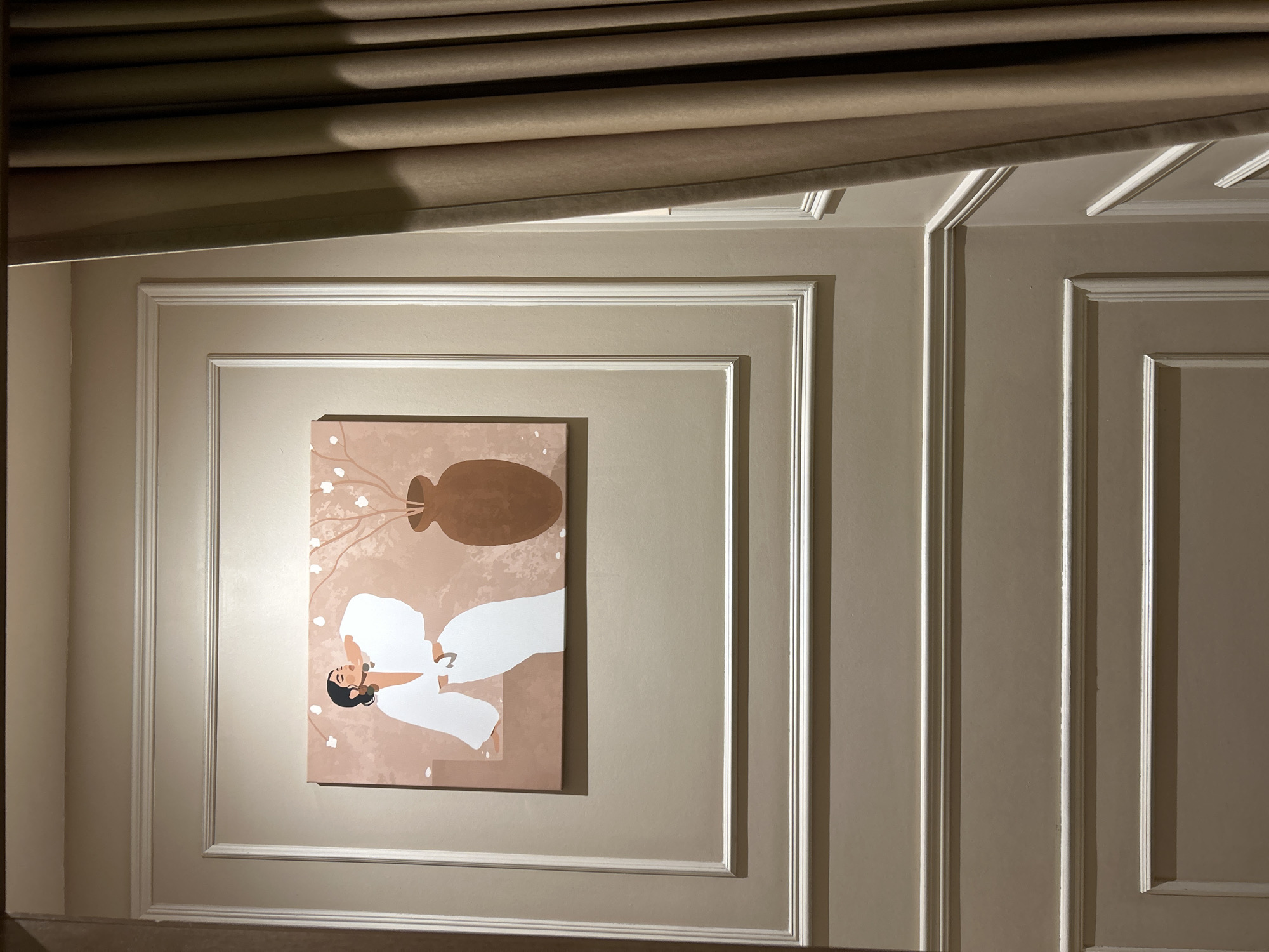 The image shows a framed painting of a woman in a white outfit with a vase and branches on a pinkish background. The painting is hung on a wall with decorative molding. To the right of the painting, a beige curtain is visible. The location is in Yekaterinburg, Russia.