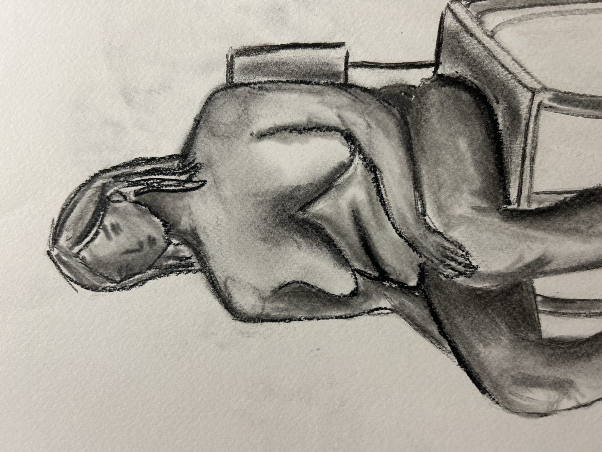 Charcoal drawing of a seated figure. The figure sits in a chair with its back to the viewer. The setting or location is not evident from the image. There is no context to infer a connection with Sofia, Bulgaria.