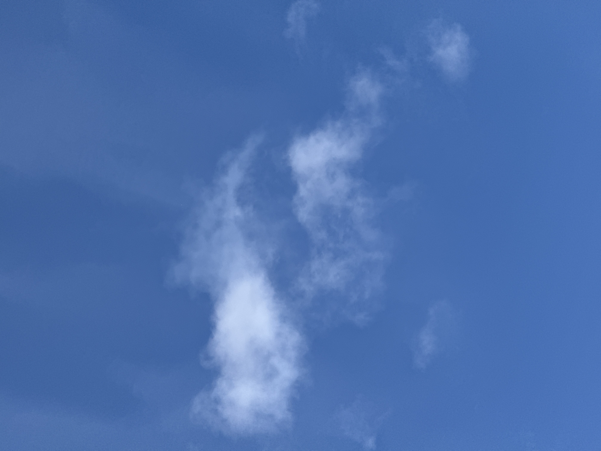 The image shows a clear blue sky with a few scattered white clouds. The clouds are wispy and appear to be high in the atmosphere. There are no other objects or people visible in the image. The location is the city of Sof'ino, Russia.