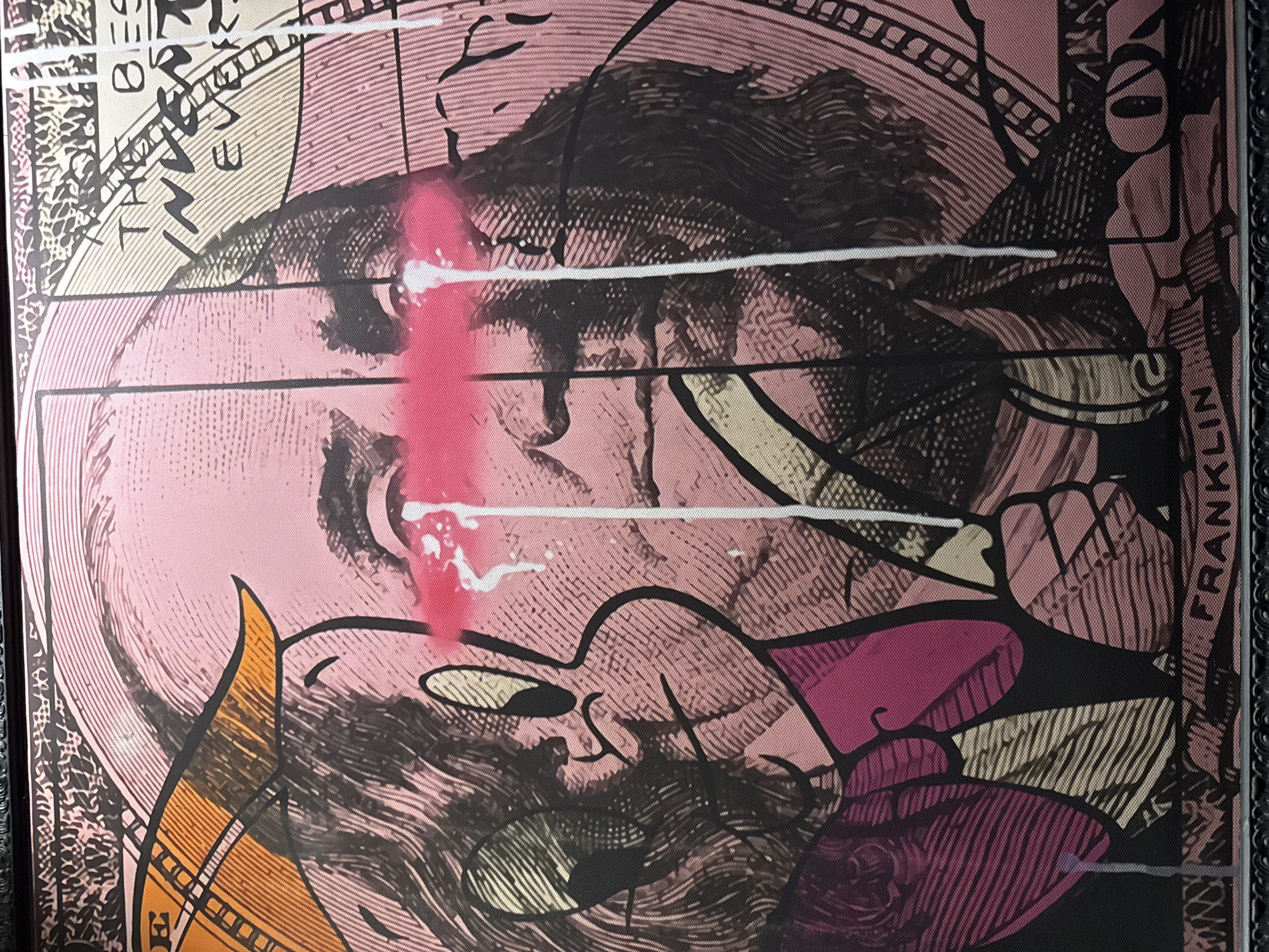 The image depicts a stylized portrait of Benjamin Franklin, rendered in pink, black, and gold tones with screen-printed textures. The word "FRANKLIN" is visible along the right edge. There is a red streak with white droplets across the face, potentially graffiti. The image appears to be a close-up photograph of a framed artwork, possibly a print or painting. There is no information about Chaikovsky, Russia, in this image.