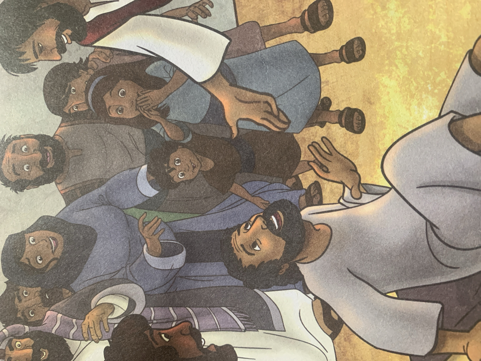 The image depicts a group of people, some appearing to be adults and others children, gathered in what appears to be an outdoor setting with a sandy ground. In the foreground, a man in a light gray tunic is sitting on the ground and looking upwards with an open mouth, his hands extended outwards. Behind him, various individuals are visible. One person in a blue garment is reaching out towards the seated man. Another individual, wearing a red and white robe, also has their hand extended. Several other figures, including men, women, and children, are in the background, some with surprised expressions. The overall scene suggests an interaction or event that is evoking a strong emotional response from the gathered individuals. The image does not provide any information or visual cues about the location being in the city of Jauro Yinu, Nigeria.