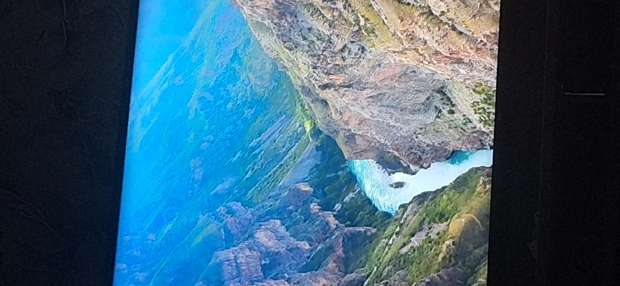The image depicts a wide, turquoise river flowing through a deep canyon. The canyon walls are steep and rocky, with patches of green vegetation clinging to the slopes. The sky above is a vibrant blue, with a hint of haze. A small boat is visible on the river, appearing to be navigating the currents. The overall impression is one of a dramatic and remote natural landscape. The location of Bila Tserkva, Ukraine is not depicted in this image.