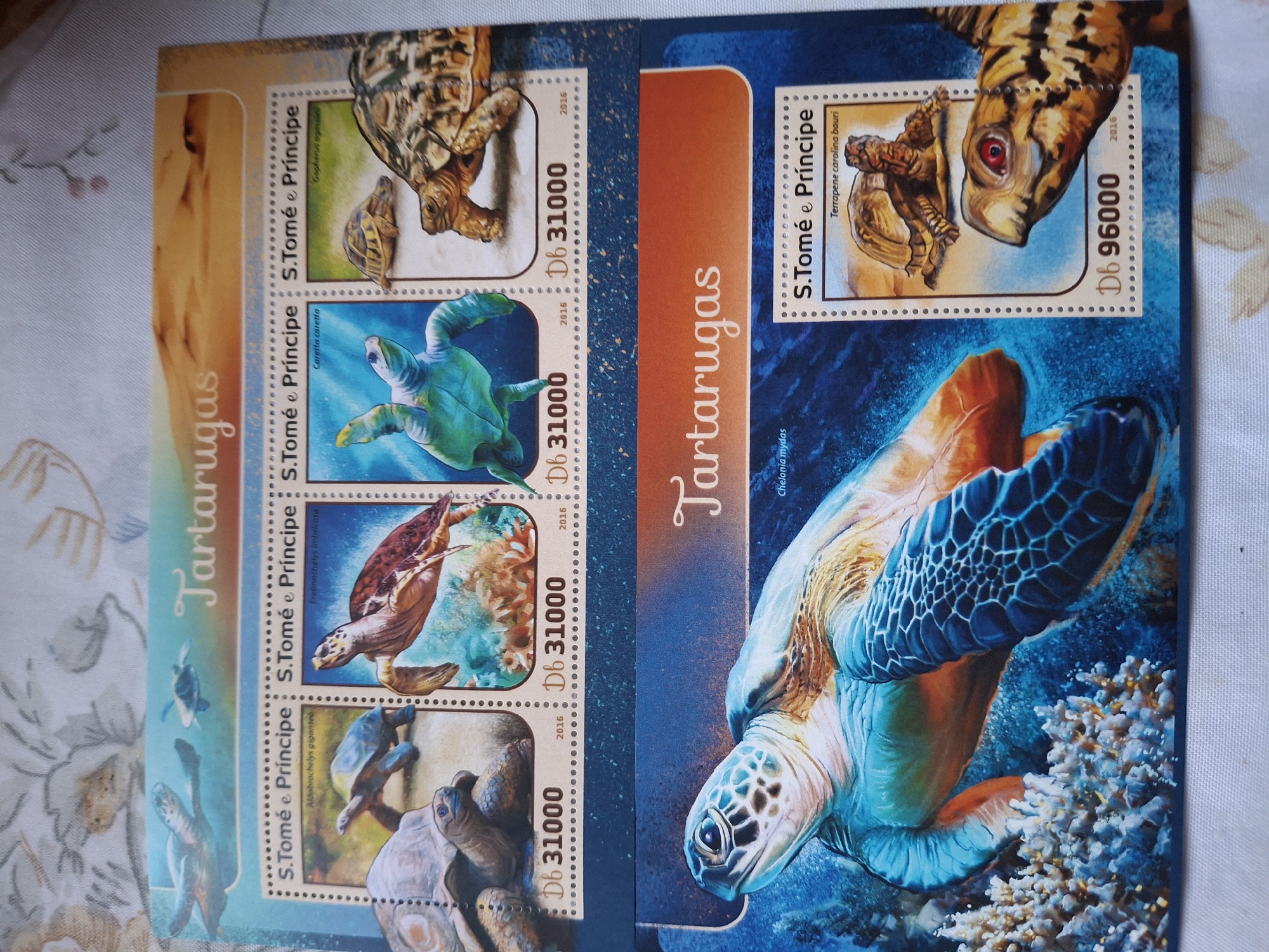 The image shows two pages of stamps from São Tomé and Príncipe, featuring turtles (Tartarugas is Portuguese for turtles). The stamps on the left page depict the following turtles: Gopherus agassizii, Caretta caretta, Eretmochelys imbricata, and Aldabrachelys gigantea. The stamps on the right page depict Terrapene carolina bauri and Chelonia mydas. The stamps have a face value in Dobras and the year 2016. The description does not include any location in the city of Pleven, Bulgaria, since the subject of the image is a collection of stamps and not the location of the image.