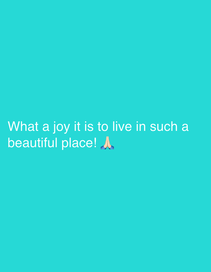 The image contains a turquoise background with white text. The text reads "What a joy it is to live in such a beautiful place!" followed by a praying hands emoji. There is no visible location in the city of Khimki, Russia, or any people, subjects, objects, actions, or interactions.