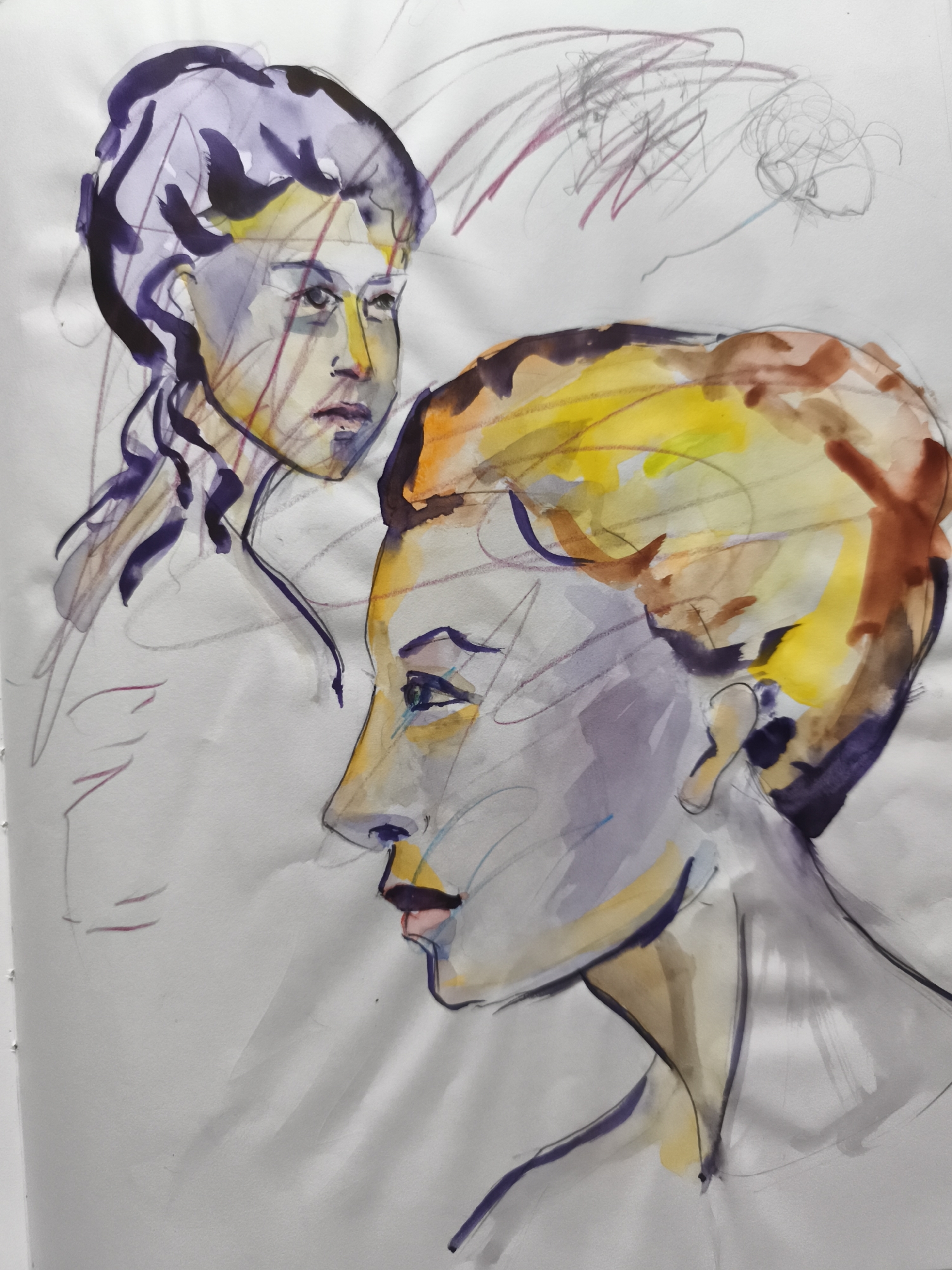 This is a watercolor and pencil sketch on paper depicting two faces in profile. The face in the foreground, on the right, is rendered in bolder strokes with prominent yellow and brown tones for the hair, and purple and pink for the lips. The face is turned to the left, with a blue and green eye visible. The second face, on the left, is more softly rendered in purples and yellows, with dark purple for the hair which is tied back. Both faces are outlined with pencil lines. The background shows abstract pencil scribbles. There are no identifiable elements that place this artwork within the city of Saint-Denis, France.