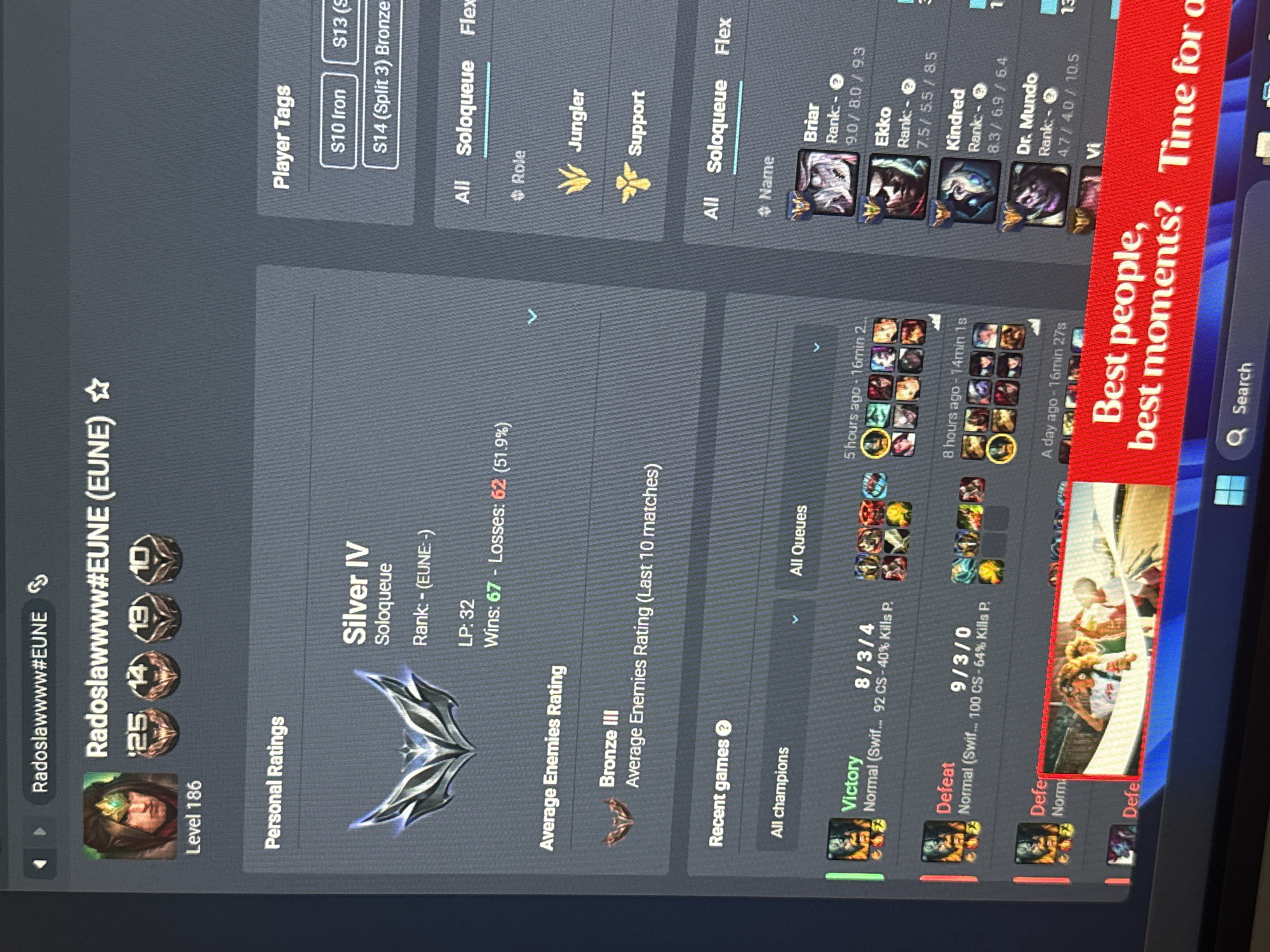 The image is a close-up screenshot of a computer screen displaying the profile of a League of Legends player named "Radoslawwww#EUNE". The profile shows the player's level (186), current rank in Soloqueue (Silver IV), win/loss ratio (67 wins, 62 losses), and average enemy rating (Bronze III). It also shows the player's recent games, including victory and defeat records with specific champion statistics. The screen also displays different game queues and champion stats from other players. An advertisement banner is partially visible at the bottom right of the screen. There is no evidence within the image to suggest that the photo was taken in Lympia, Cyprus, or any other specific location.