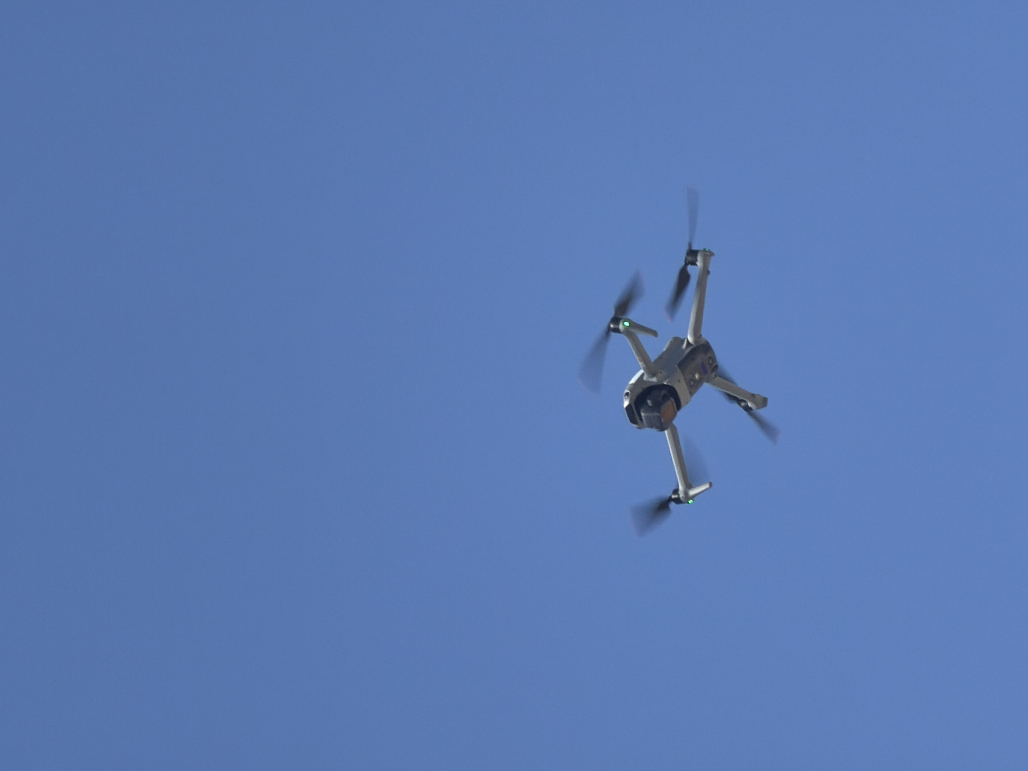 A drone is flying in a clear blue sky. The location is not specified in the image. There is nothing to indicate the location as Tel-Aviv, Israel.