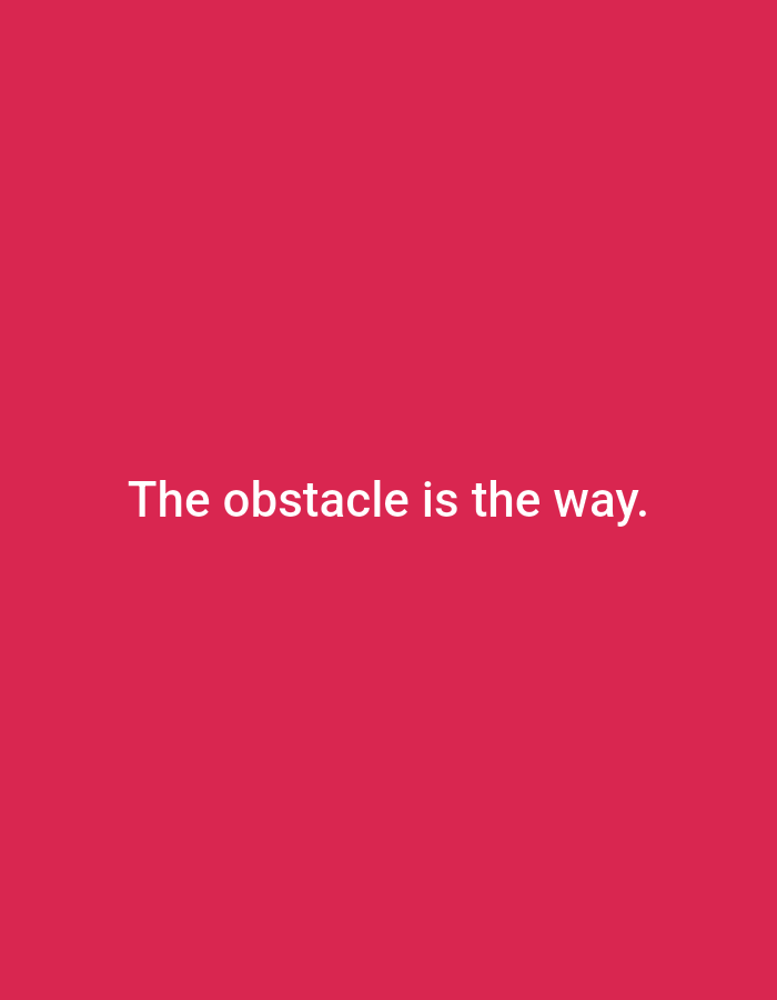 A white quote is displayed on a solid magenta background. The quote reads, "The obstacle is the way." The text is centered horizontally and vertically on the image.