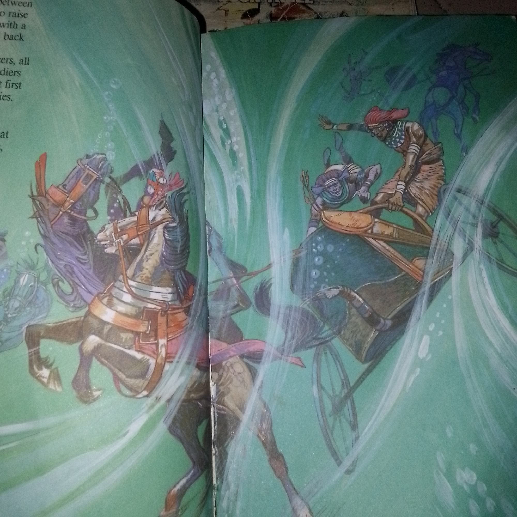 The image depicts a chaotic scene of battle or disaster, with horses and chariots submerged in what appears to be water, possibly a river or flood. The figures are rendered in a stylized, illustrative manner. On the left, two horses are prominently featured, one a reddish-brown and the other a lighter color, both harnessed to chariots. One horse on the left seems to be struggling, its front legs raised. In the center and right of the image, a chariot is shown with two figures. One figure, wearing a red headdress and patterned clothing, is actively engaged, reaching out with one arm. Another figure is falling or submerged. Several other horses, some outlined in blue, are visible in the background, adding to the sense of disarray. The background is a uniform green, with swirling white lines that suggest movement or currents, reinforcing the aquatic setting. Bubbles are scattered throughout the scene, indicating submersion.
The provided context mentions Jalingo, Nigeria. Without further information or visual cues in the image that are specific to Jalingo, it is not possible to determine the scene's location within that city. The image itself does not contain any recognizable landmarks or elements that would place it in Jalingo.