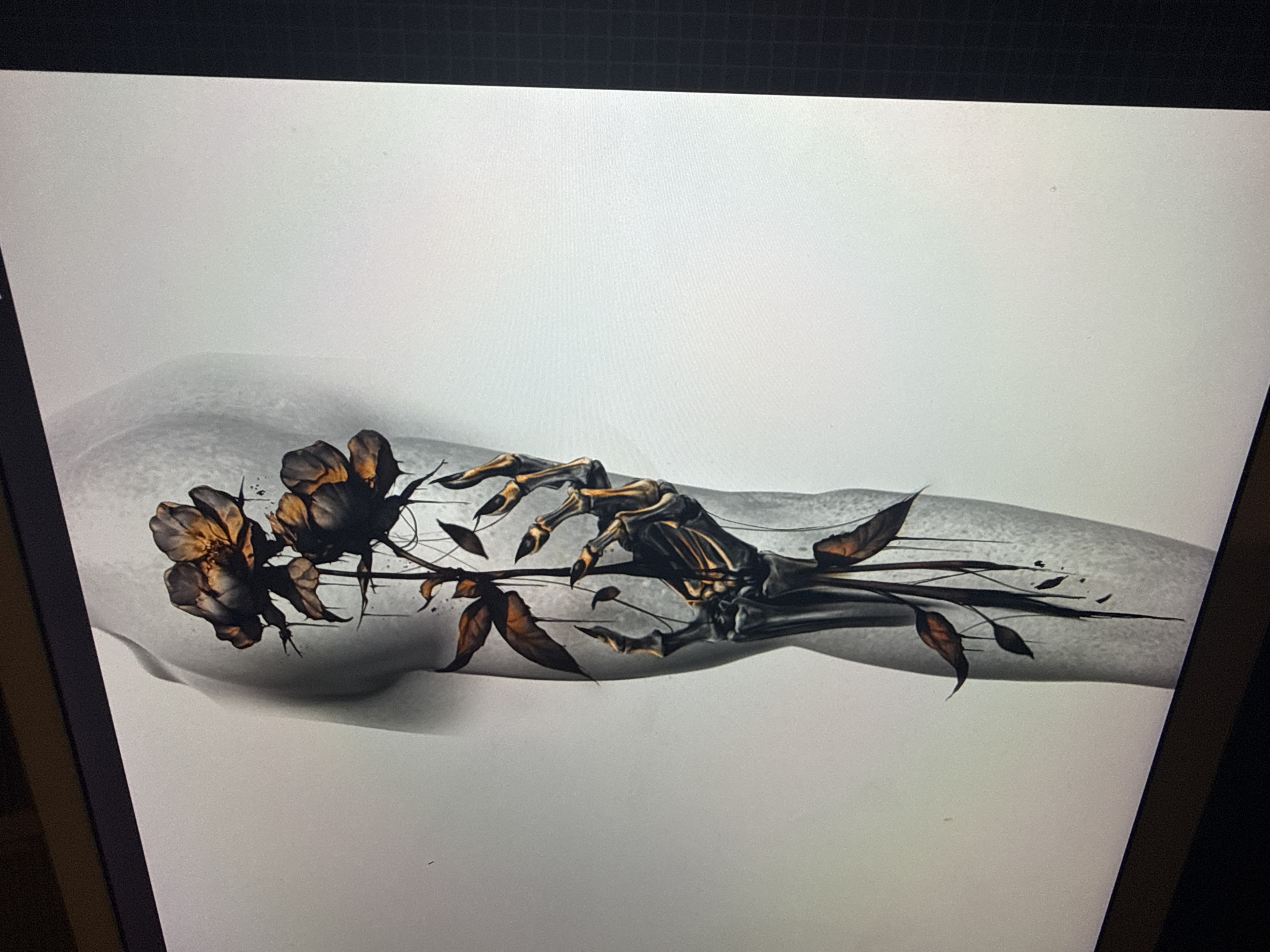 The image depicts a tattoo design on what appears to be an arm. The design features three dark roses and a skeletal hand clutching their stems. The arm itself is shaded in grayscale, while the roses have hints of brown and gold. The skeletal hand is detailed with bone structure and has darkened shading. Thin lines represent the stems and scattered leaves, extending from the roses to the hand. The background is a light gray. The location in Sofia, Bulgaria, cannot be ascertained from this image.