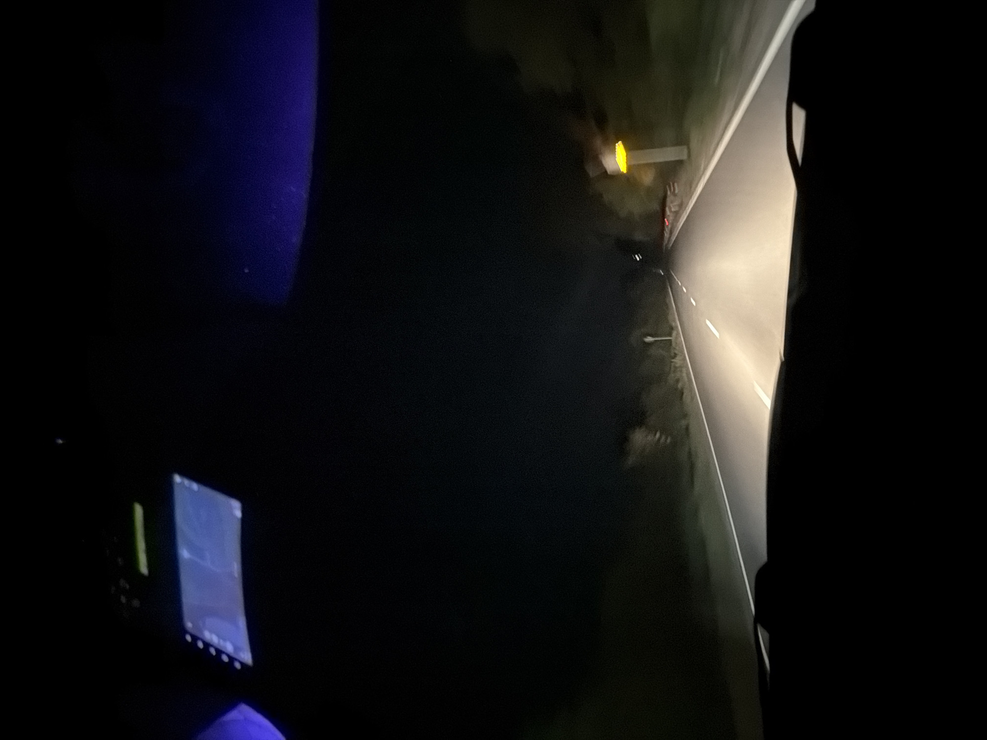 The image appears to be taken from inside a vehicle at night on a road. The road has visible lane markings and road signs. A lit screen is visible inside the vehicle. The location is claimed to be Borovtsi, Bulgaria.