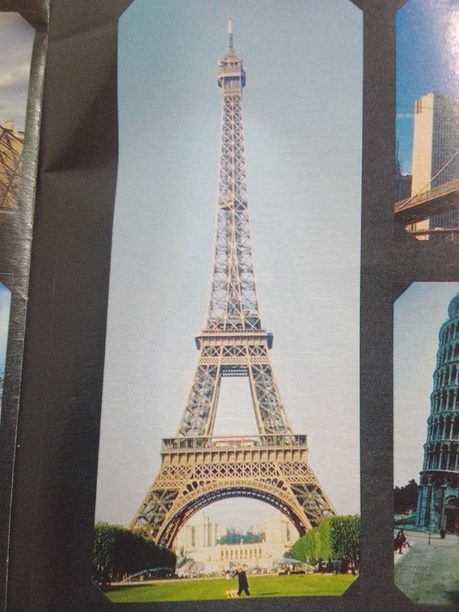 The image features a collage of famous landmarks. The most prominent subject is the Eiffel Tower in Paris, France, seen from a low angle against a clear sky. To the right of the Eiffel Tower, the Leaning Tower of Pisa is visible, also against a bright sky. In the upper right quadrant of the collage, a modern skyscraper and a bridge are depicted. The bottom portion of the image shows a grassy park area with trees and a few people walking. The city of La Tagua, Venezuela is not depicted in this image.