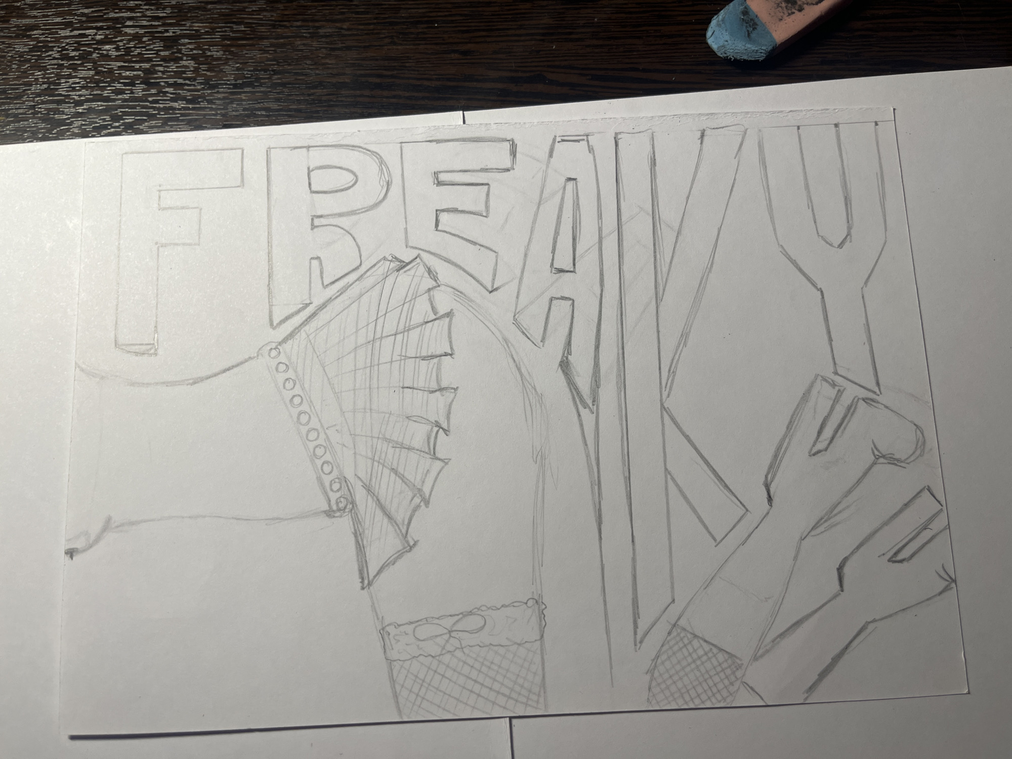 A pencil sketch on white paper depicts the word "FREAKY." The letters are drawn in a blocky, stylized font, with illustrations partially obscuring them. A hand wearing a ruffled glove is positioned near the left side. Further to the right, partially obscured behind the letter "Y," a pair of legs clad in fishnet stockings are visible. The sketch is placed on a dark wooden surface. A pink and blue eraser is partially visible in the upper right corner. The location of the scene is not depicted and not discernible from the information given.