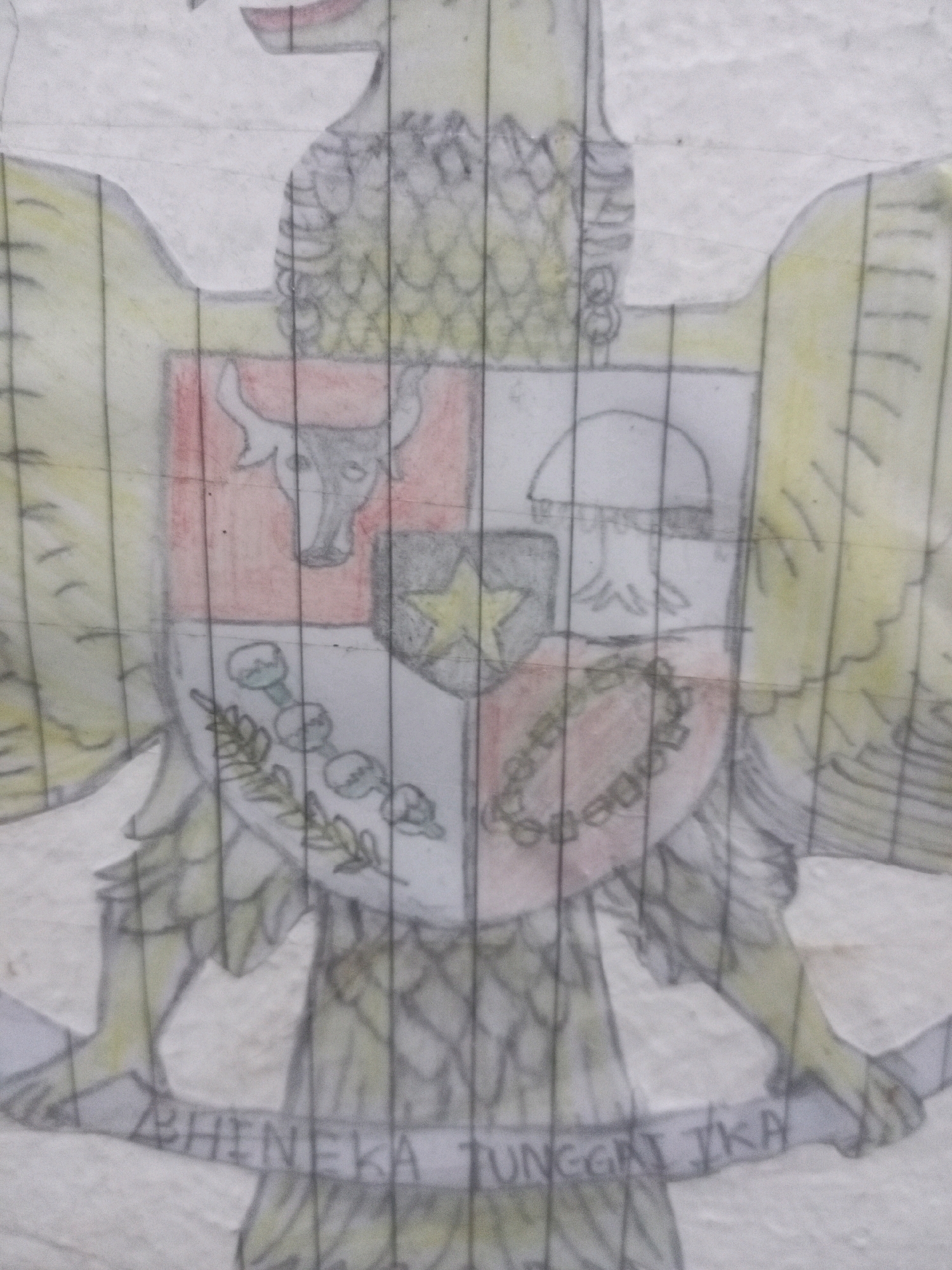 The image is a drawing of the Garuda Pancasila, the national emblem of Indonesia. The drawing is done in colored pencil and appears to be on paper. The Garuda is depicted with its wings spread, and its chest is adorned with a shield divided into four quadrants. Each quadrant contains a symbol: a bull's head in the upper left, a banyan tree in the upper right, a star above chains in the lower half, and a rice stalk and cotton bolls in the lower left. Below the shield, a banner displays the national motto "Bhinneka Tunggal Ika" in all capital letters. The drawing is overlaid with vertical black lines, suggesting it might have been photographed through a window blind or a similar textured surface. The overall impression is that of a stylized representation of a national symbol, likely created as a personal artwork. The location context of Batam, Indonesia, confirms the relevance of the Garuda Pancasila as the national emblem of the country. There are no visible cues for time of day, weather, or specific emotions conveyed by the artwork itself.