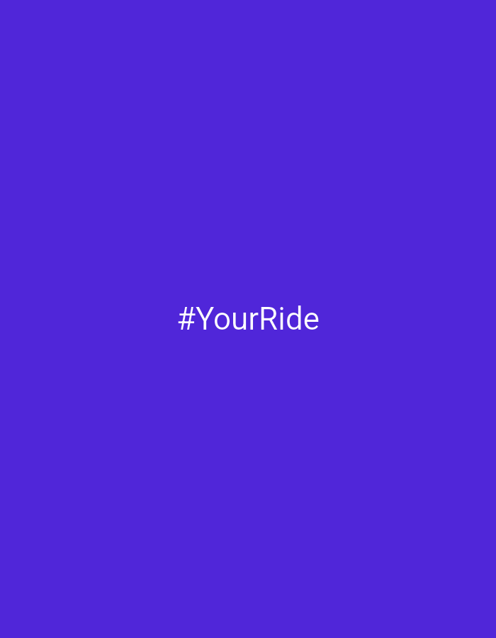 The image displays a simple graphic with white text centered on a solid, vibrant purple background. The visible text is a hashtag, "#YourRide," rendered in a clean, sans-serif font. There are no people, objects, or specific scenes depicted in the image, making it an abstract visual. No activity or event is directly shown, but the hashtag suggests a theme related to transportation, travel, or a journey. Notable details are limited to the color scheme and the text itself. The background is a uniform, rich shade of purple, filling the entire frame. There are no visual cues for time of day, weather, or a specific physical location within Markovskii, Russia, as the image's content is purely digital and symbolic. The image serves to highlight the hashtag "#YourRide."