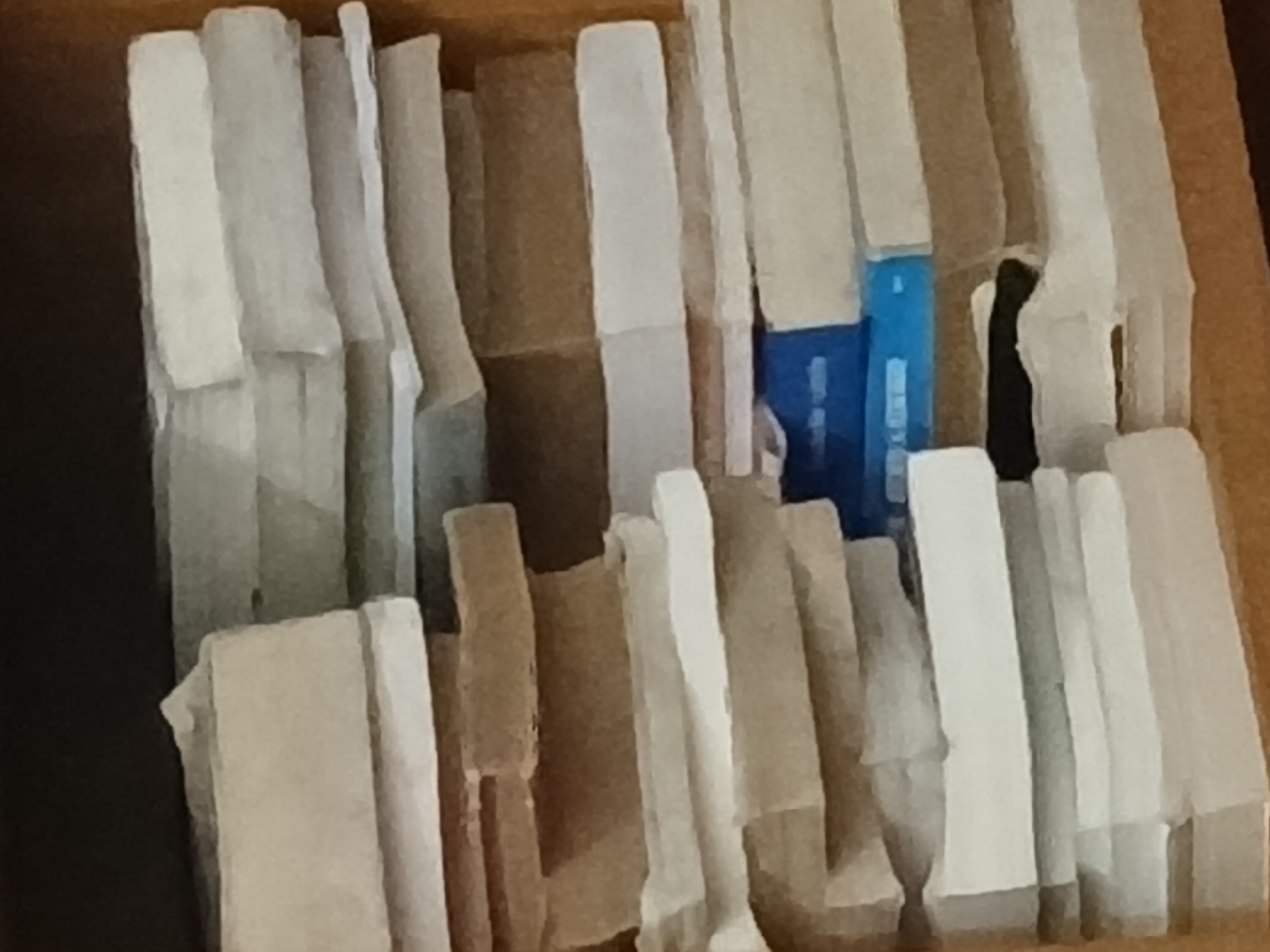 The image shows a container, likely a drawer, filled with white and beige-colored rectangular objects. One blue object is visible among the rest. The objects appear to be densely packed and are arranged vertically. It is impossible to ascertain the location in Buenos Aires, Argentina.