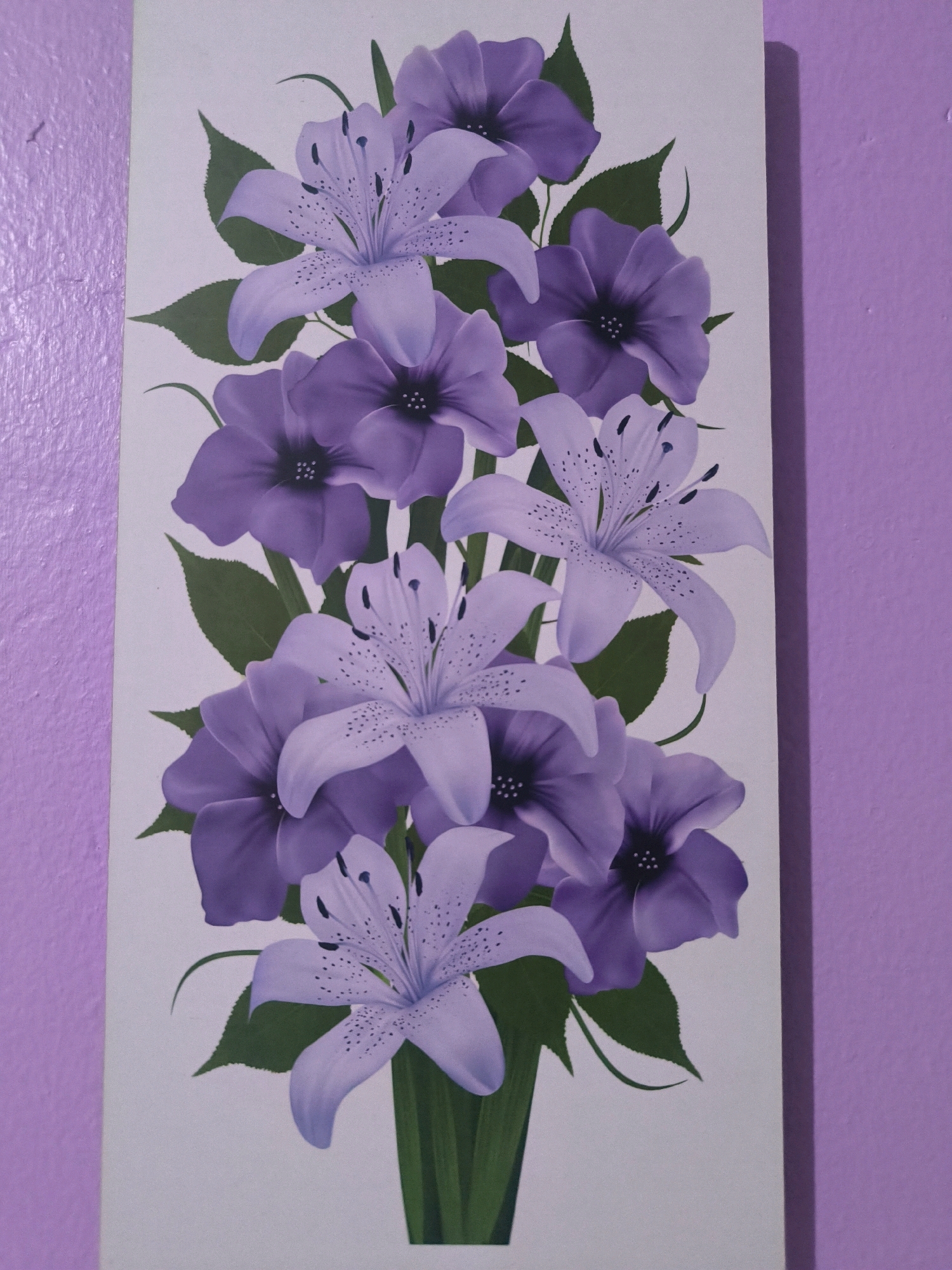 A vertical, digitally rendered painting of a bouquet of purple lilies and other purple flowers is displayed against a white background. The flowers are arranged in a vase at the bottom of the painting, with stems and green leaves supporting the blooms as they fan out upwards and to the sides. The lilies are light purple with darker purple speckles on their petals, while the other flowers are a deeper shade of purple with dark centers. The painting is propped against a textured, lavender-colored wall, with the left edge of the painting touching the wall. The scene is lit from the right, casting a subtle shadow on the wall behind the painting.
