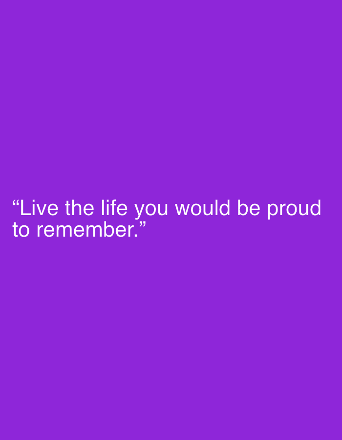 The image is a minimalist digital graphic featuring a motivational quote against a solid, vibrant purple background. The text is rendered in white, sans-serif font, enclosed in quotation marks, and reads: "Live the life you would be proud to remember." The quote is presented in two lines, horizontally centered but positioned towards the bottom-left area of the frame. There are no other visible subjects, objects, or people in the image. No specific activity or event is depicted, as it is a static text-based graphic. Notable details include the stark contrast between the white text and the deep purple background, which enhances readability. There are no visual cues regarding time of day, weather, or a specific physical location within the image itself. The overall presentation is clean and direct, designed to highlight the inspirational message.