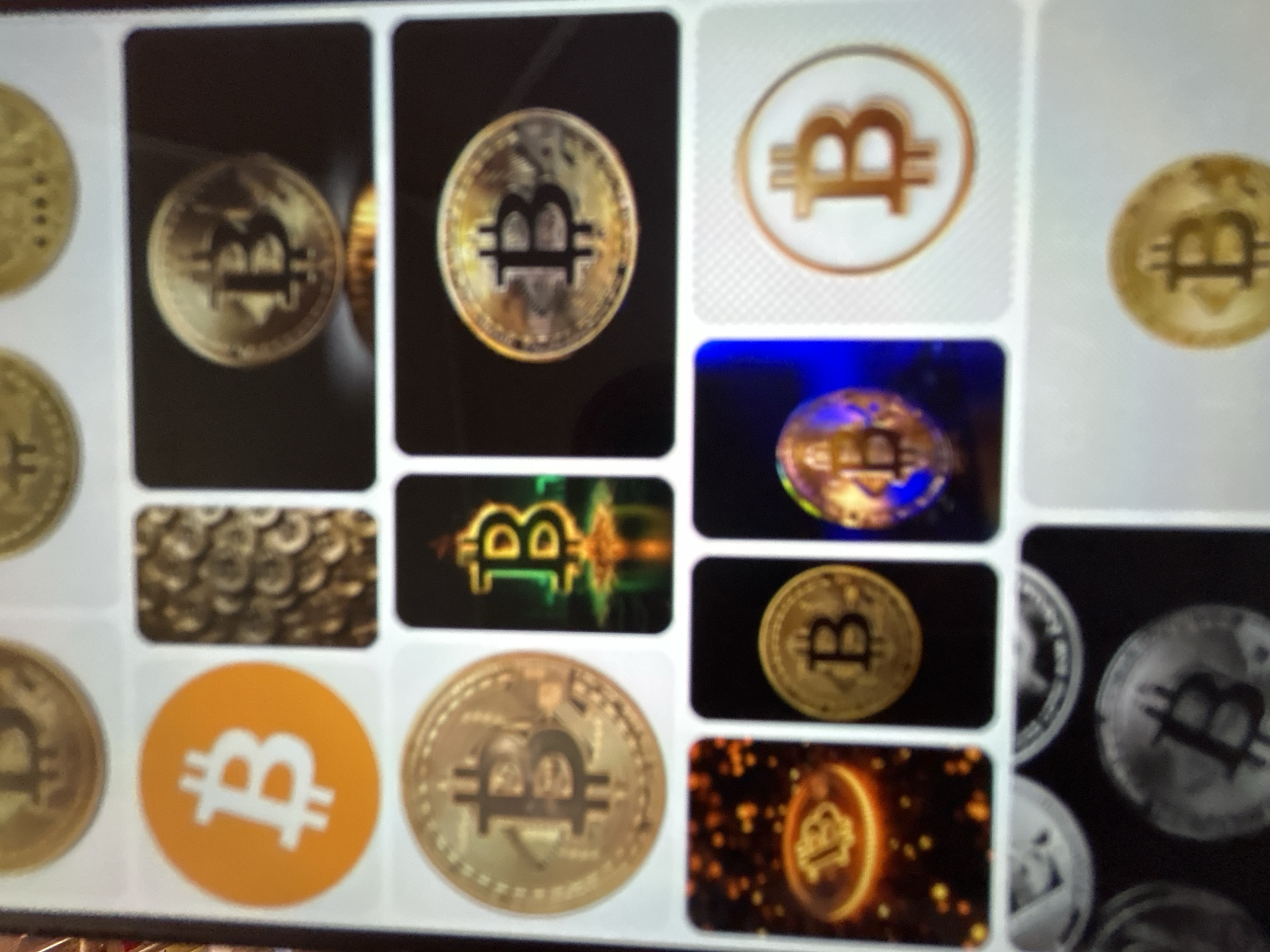 The image shows a grid of Bitcoin-related images. There are multiple instances of the Bitcoin logo and stylized representations of Bitcoin coins. Some images are close-ups of golden coins with the Bitcoin symbol, while others feature the logo on colored backgrounds. One image shows a stack of coins. Another displays the Bitcoin logo illuminated with colorful lights. The background appears to be a digital interface or screen. The image does not contain any recognizable landmarks or elements specific to the city of Gelendzhik, Russia. There are no people, actions, or interactions depicted.