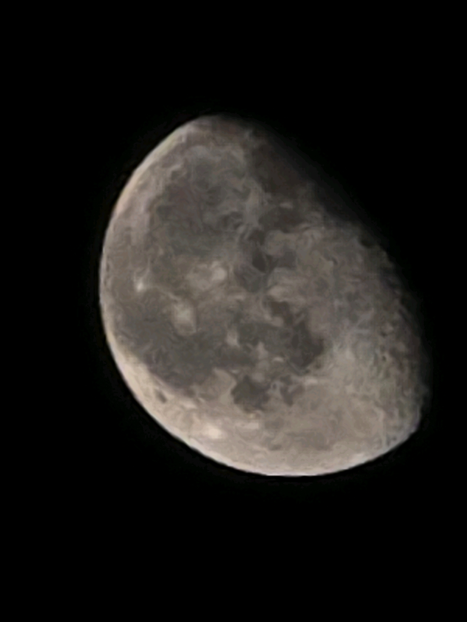 The image shows a close-up view of the Moon against a black background. The Moon is partially illuminated, with the illuminated portion appearing as a crescent shape. The surface of the Moon is visible, showing craters and other geological features. The image is a photograph taken from Earth, likely with a telescope. There is no indication of the city of Yambol, Bulgaria, or any other specific location.