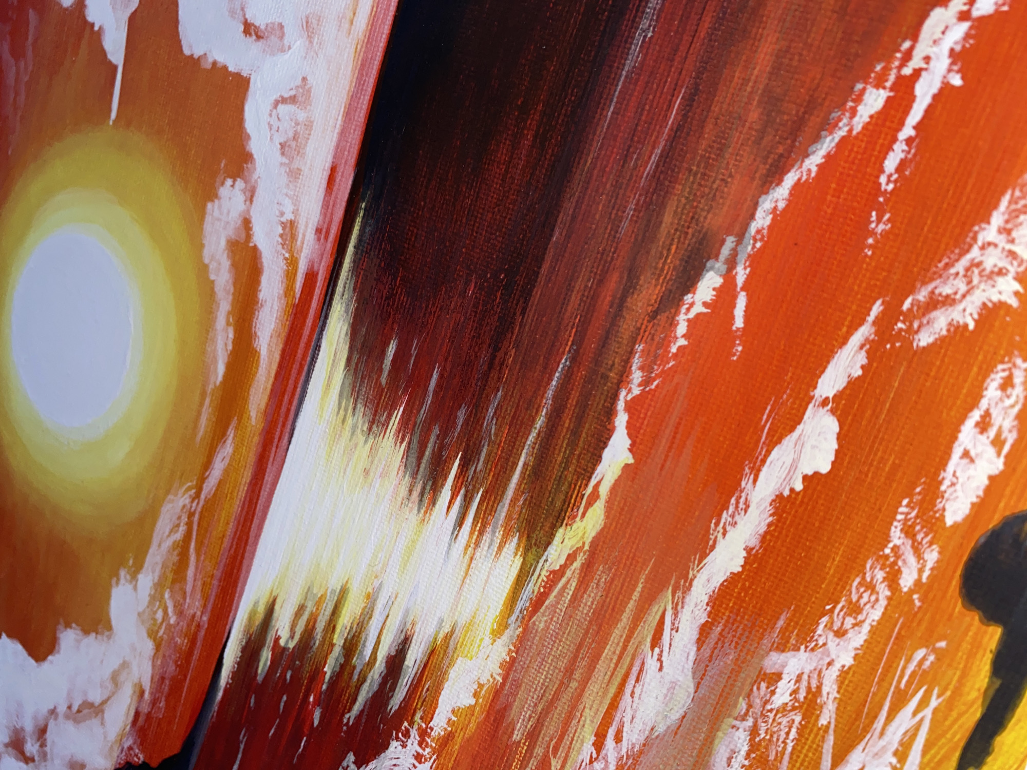 This media file showcases a close-up, angled view of a vibrant and expressive painting, likely executed in acrylic or oil on canvas. The artwork is characterized by bold brushstrokes and a rich palette dominated by warm colors: oranges, reds, yellows, and stark whites.
The painting appears to be composed of at least two panels or sections, joined at an oblique angle. The leftmost section features a prominent, luminous circular form in white and yellow, representing the sun, set against a bright orange sky. Around the sun, textured white brushstrokes suggest clouds.
Moving towards the center, the painting transitions into a dark, rich reddish-brown area, created with dense, vertical, and diagonal strokes. This section provides a strong contrast to the bright light of the sun, possibly depicting distant land, mountains, or a shadowed part of the landscape.
The rightmost section is a burst of intense orange and red, interspersed with energetic, diagonal brushstrokes of white and yellow. These strokes convey movement and reflection, possibly illustrating light on water or an abstract representation of energy within the scene. A dark, partially visible, abstract shape or silhouette can be discerned at the far right edge.
The overall scene evokes a dramatic sunrise or sunset, capturing the powerful interplay of light and color found in nature. The visible texture of the canvas and the impasto (thick application of paint) add to the artwork's dynamic feel. Although abstract, the vibrant tropical hues are consistent with the beautiful natural landscapes, particularly sunrises and sunsets, often experienced in Davao City, Philippines. There is no visible text in the image.