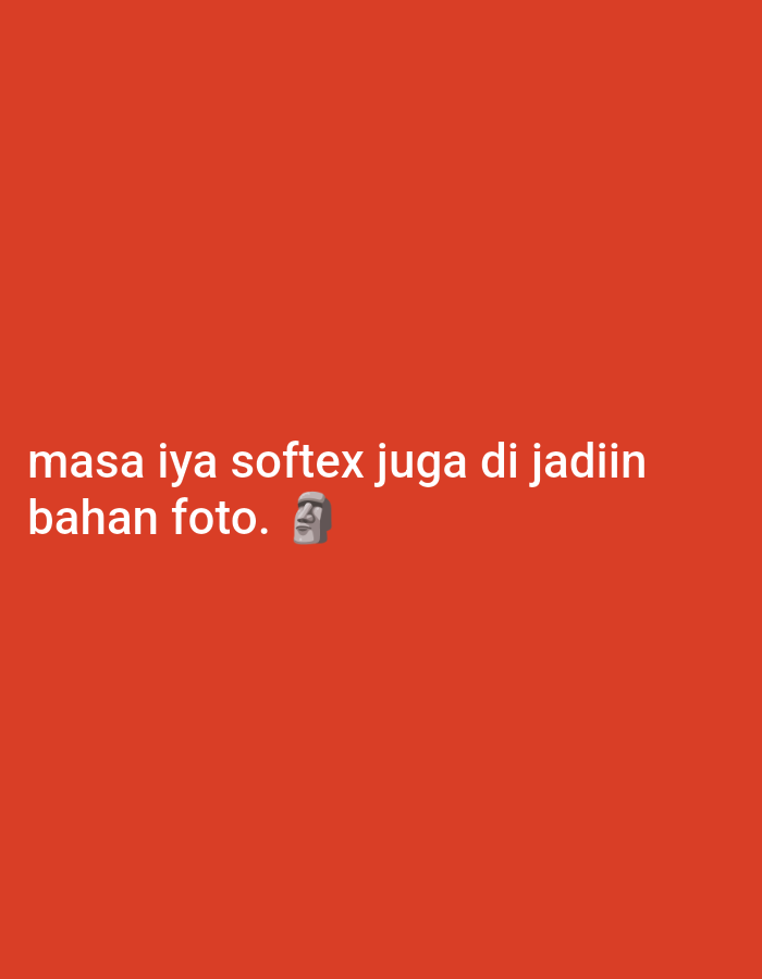 A digital image features white text on a vibrant red background. The text reads, "masa iya softex juga di jadiin bahan foto." The image also includes a small emoji of a Moai statue. The image does not contain any information or visual cues related to the city of Guwosari, Indonesia, or any specific location within it.