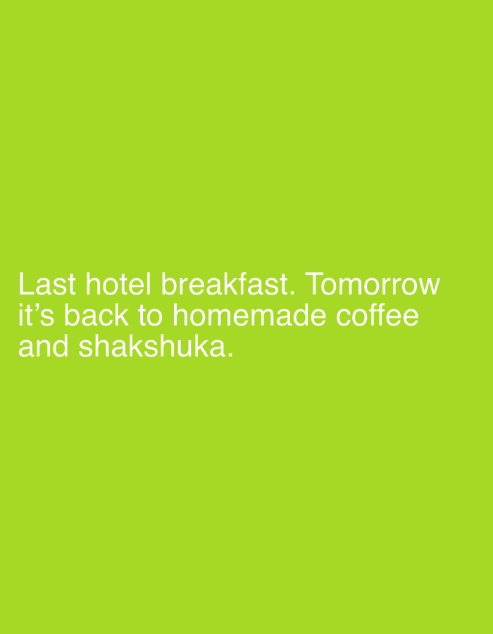 The image shows white text on a bright green background. The text reads: "Last hotel breakfast. Tomorrow it's back to homemade coffee and shakshuka." There are no people, objects, or discernible environmental features. The image does not contain any information about the city of Tbilisi, Georgia.