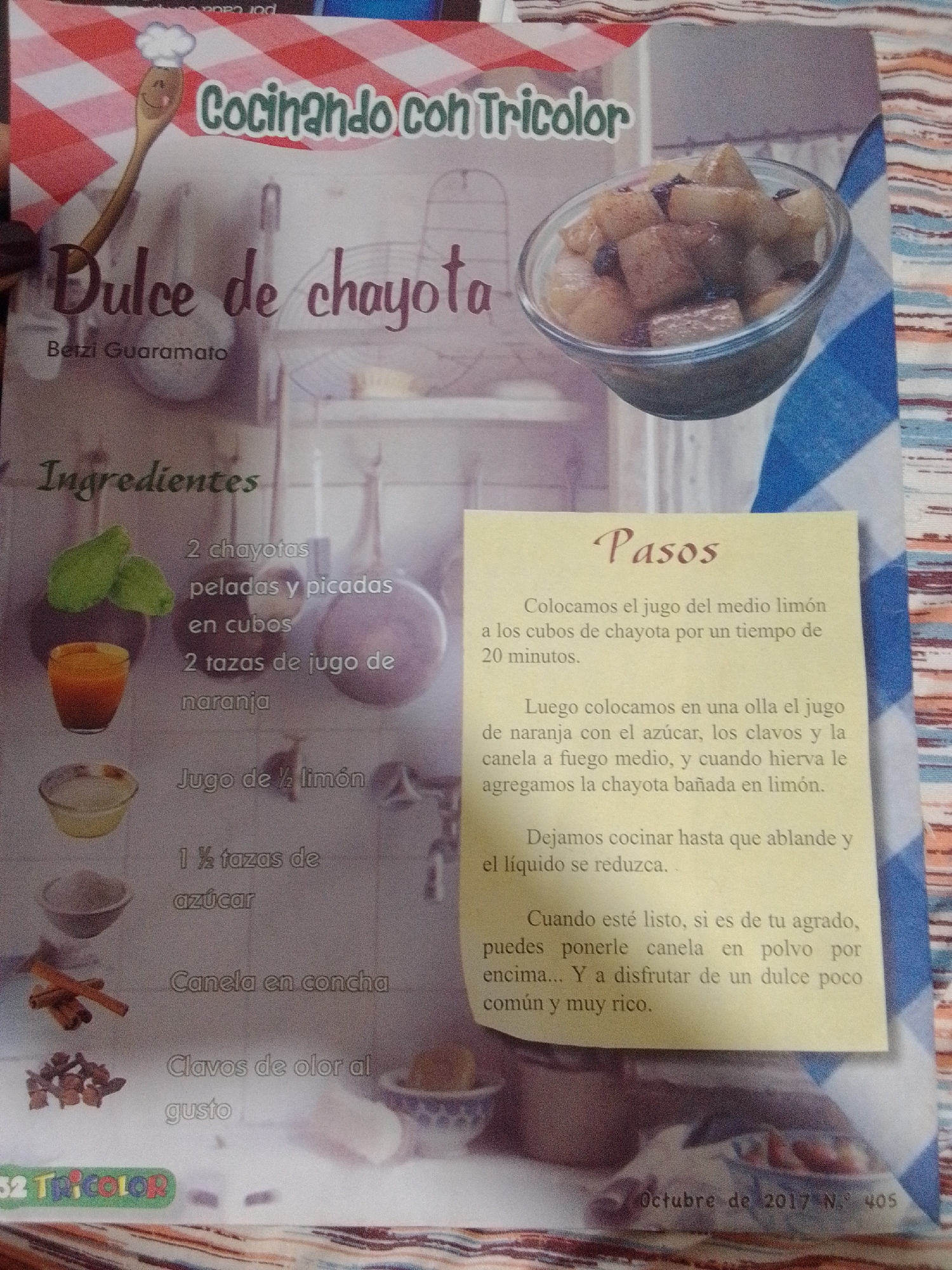 The image is a photograph of a recipe for "Dulce de chayota" from "Cocinando con Tricolor". The recipe is presented in Spanish with a picture of the finished dish and ingredients. The text includes "Ingredientes" (Ingredients) and "Pasos" (Steps). The ingredients listed are chayotas, orange juice, lemon juice, sugar, cinnamon sticks, and cloves. The steps describe how to prepare the dish. The bottom of the image contains the text "Octubre de 2017 N. 405" and a logo that appears to say "32 Tricolor". There is no information or imagery that places this photo in La Tagua, Venezuela.