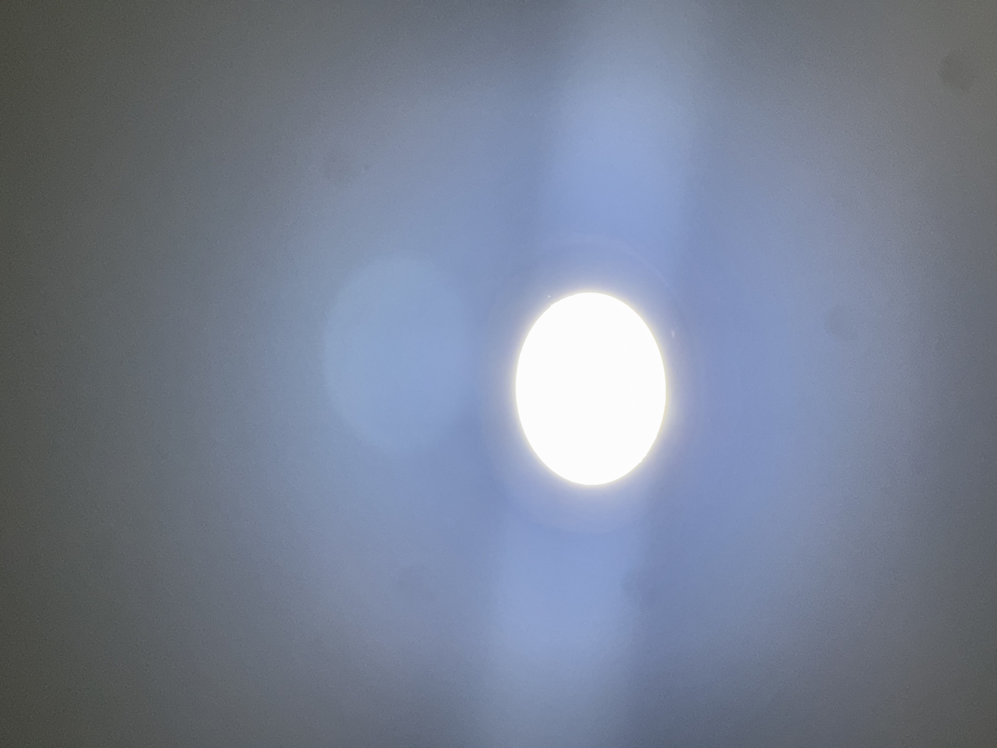 The image shows a ceiling with a bright, circular LED light fixture. The surrounding ceiling area appears to be painted in a muted gray tone. There are also some visible marks or imperfections on the ceiling surface. The image does not contain sufficient information to determine a specific location in Đà Nẵng, Vietnam.