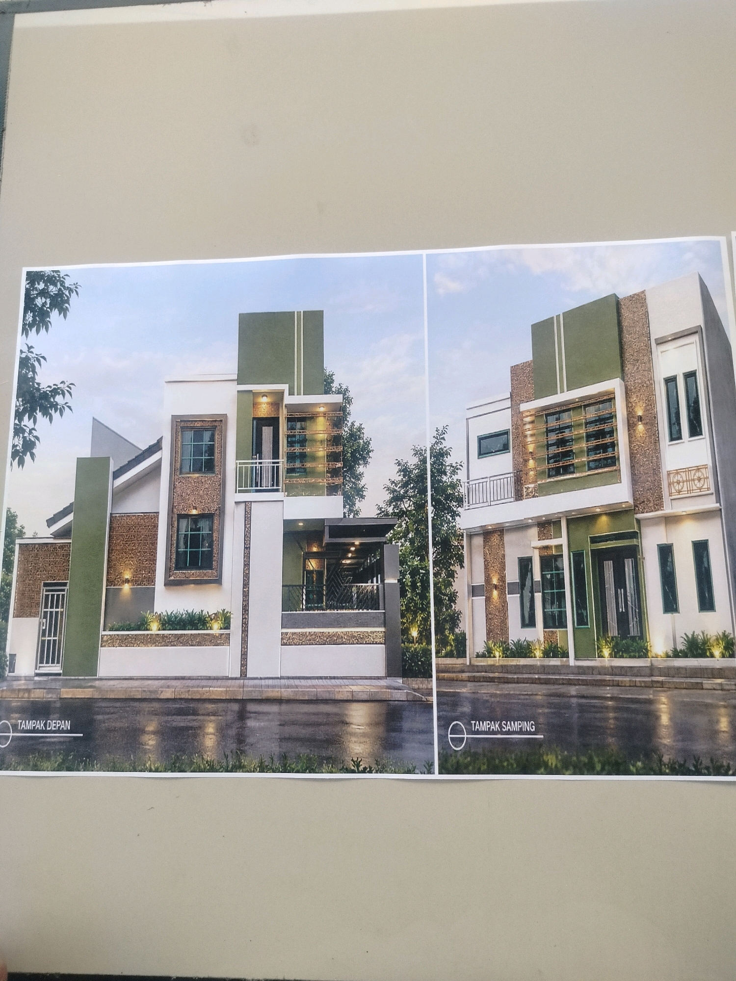 The image displays two architectural renderings of a modern two-story house. The left rendering shows a front view, labeled "TAMPAK DEPAN," and the right rendering presents a side view, labeled "TAMPAK SAMPING." Both images depict a house with a white and green facade, featuring geometric patterns and large windows. The architectural style is contemporary, with clean lines and a mix of materials like stone cladding and painted surfaces. The renderings are placed on a neutral-toned surface, possibly a wall or a board, and appear to be printouts. The background of the renderings shows a sky with clouds and some trees, suggesting an outdoor setting. There are no people or specific landmarks indicating a precise location within East Jakarta, Indonesia. The overall presentation suggests a design proposal or visualization for a residential property.