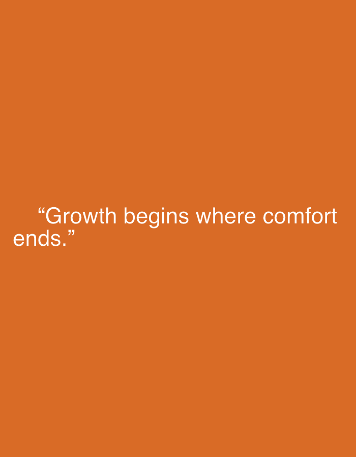 The image displays a simple, text-based graphic on a solid orange background. The orange color is uniform across the entire frame. Centered horizontally and slightly below the vertical midline, a motivational quote is presented in white, sans-serif typography. The text is enclosed in quotation marks. The quote reads: "Growth begins where comfort ends." The font appears clean and modern, providing a strong contrast against the vibrant orange, making it easily readable. There are no other objects, people, or discernible settings in the image.