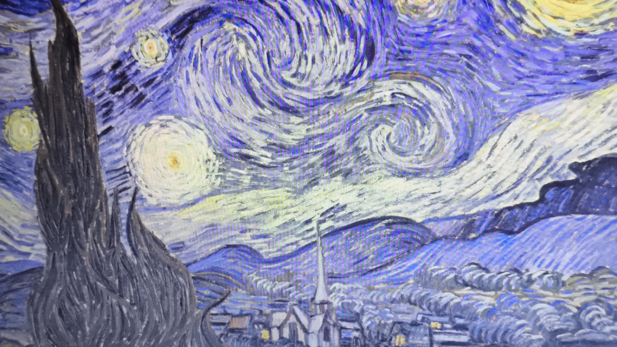 This image is a reproduction of Vincent van Gogh's "The Starry Night." It depicts a night sky with swirling clouds, stars, and a bright moon. In the foreground, there is a dark, stylized cypress tree. Below the sky, there is a town with a church steeple. The scene uses bold brushstrokes and vibrant colors of blues, yellows, and whites. This is a stylized and expressive depiction of a night landscape, not a literal representation of a place in Nowy Tomyśl, Poland or anywhere else.