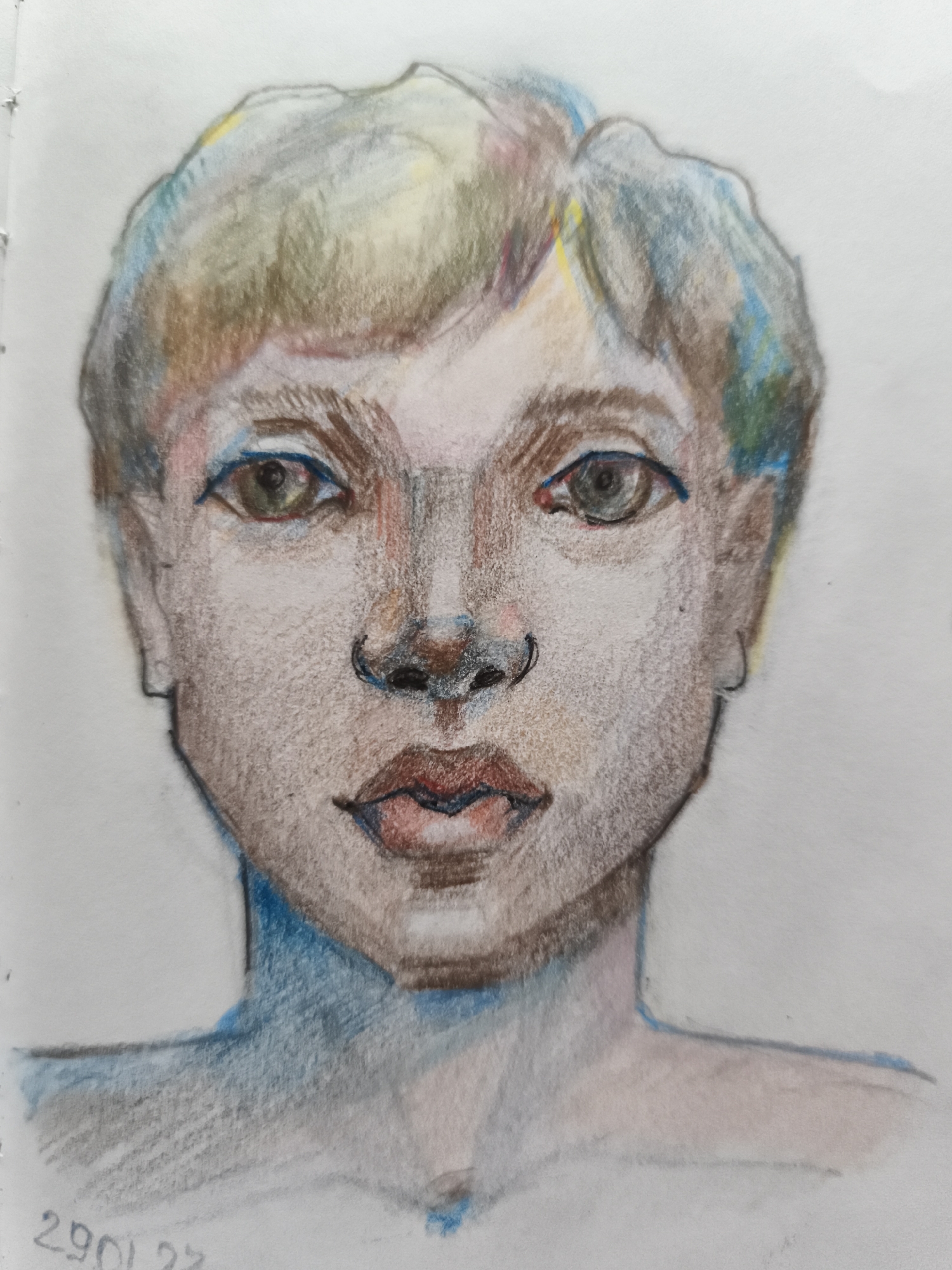 A colored pencil drawing depicts a frontal portrait of a person's head and shoulders against a white background. The subject has short, tousled hair with visible streaks of yellow, green, and blue. Their facial features are rendered with subtle shading and a mix of warm and cool tones. The eyes are wide open, with brown irises. The nose is slightly upturned, and the lips are full with a reddish hue. The jawline is defined, and the neck and shoulders are lightly sketched with blue and gray tones. A date, "29 01 23", is inscribed in the lower left corner of the drawing. This image is a creative work and not a depiction of a real-world scene in Saint-Denis, France.