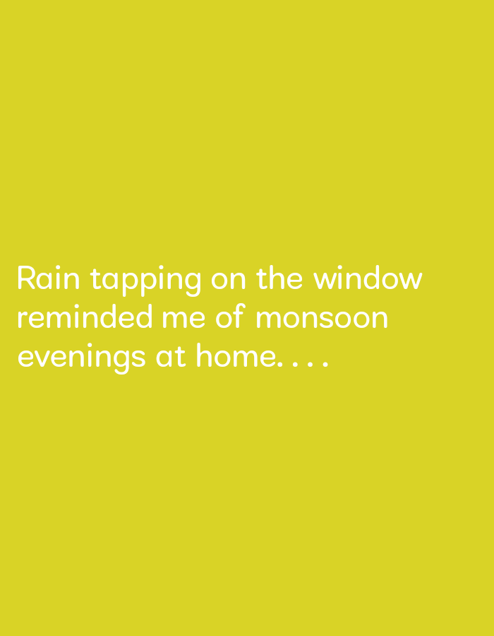 The image is a solid yellow background with white text that reads "Rain tapping on the window reminded me of monsoon evenings at home...". The provided coordinates, 17.809 latitude and 83.198 longitude, correspond to a location in the city of Visakhapatnam, India.