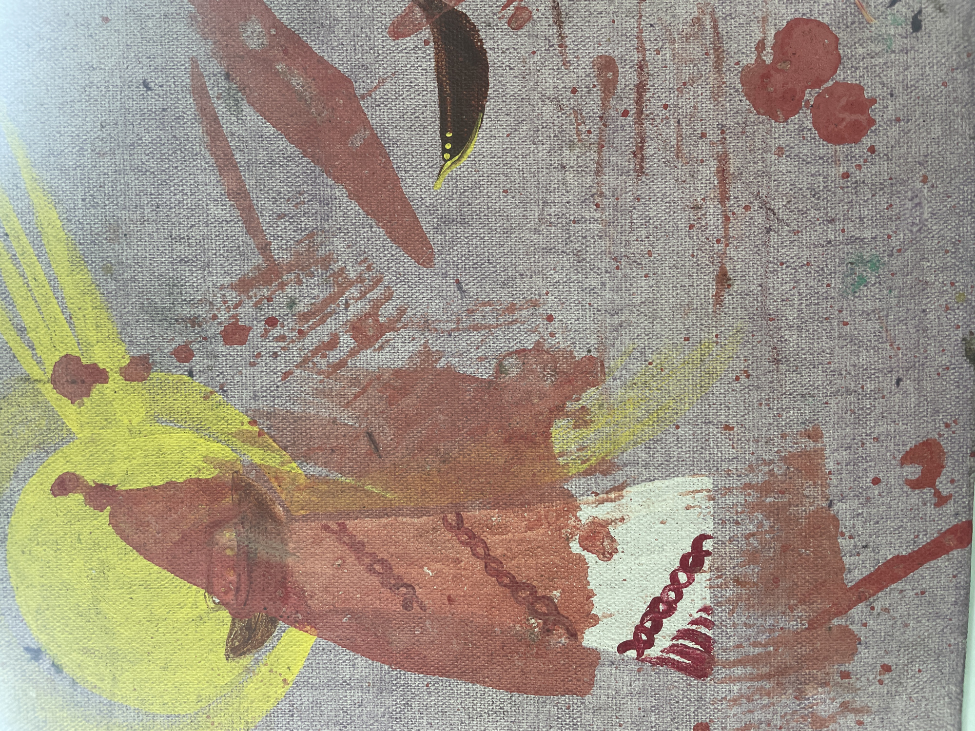 The image is a close-up of a painting on a textured surface, possibly canvas. The painting features abstract and figurative elements in red, yellow, and brown paint, with visible brushstrokes and paint splatters. On the left side, there is a figure or object depicted with a red triangular shape overlaid with a yellow circle. Below this, a white rectangular area has a red chain-like pattern and red vertical lines. To the right, a brown bird-like shape with yellow eyes and a yellow beak is visible against a background of red slashes and splatters. The overall style appears to be expressive and somewhat raw. The painting's location in Bhagsu, India, is not visually evident from the image itself.