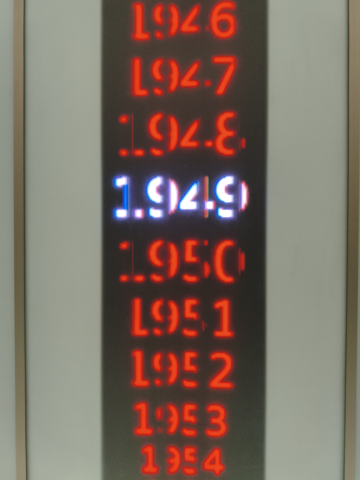 The image shows a vertical display of neon numbers, likely a scoreboard or a countdown. The numbers are red, except for the center number which is white and blue. The display is set against a dark background and is framed by a light-colored border. There are no people or discernible actions depicted in the image. The specific location in Ingolstadt, Germany is not provided.