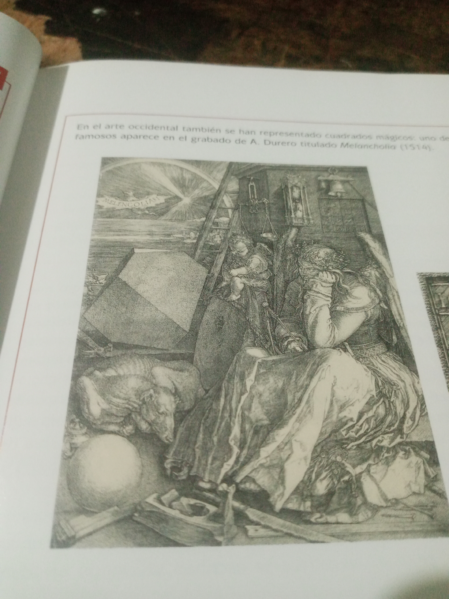 The image depicts a page from a book featuring a black and white engraving. The text above the engraving reads in Spanish, "En el arte occidental también se han representado cuadrados mágicos: uno de los más famosos aparece en el grabado de A. Durero titulado Melancolía (1514)." This translates to, "In Western art, magic squares have also been represented: one of the most famous appears in the engraving by A. Dürer titled Melancholy (1514)."
The engraving itself is a detailed scene of a winged female figure, presumably Melancholy, seated and appearing pensive or dejected. She is surrounded by various symbolic objects. To her left, a polyhedron or geometric solid is prominently displayed. Behind her, there's a ladder, a scale, and other tools or instruments. A cherub or putto is perched on her shoulder. In the lower left of the engraving, there is a sphere and a bat carrying a banner with the inscription "MELENCOLIA". A dog lies near her feet. The overall atmosphere is somber and intellectual.
There is no information in the provided image or text that indicates any connection to the city of Santa Ana, Venezuela.