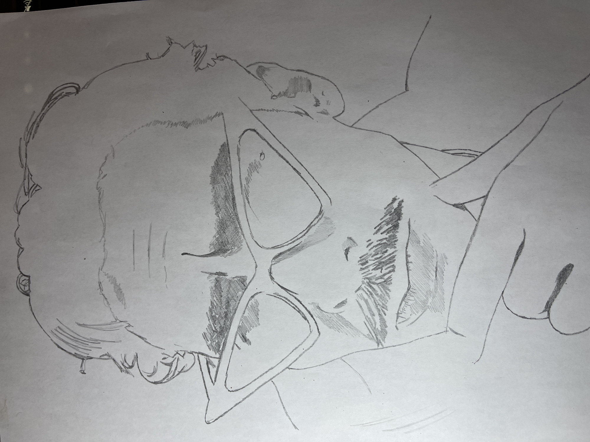 A pencil sketch depicts a person wearing glasses lying down. The person is resting their head on their arm. The location of Jos, Nigeria is not discernible from the drawing.