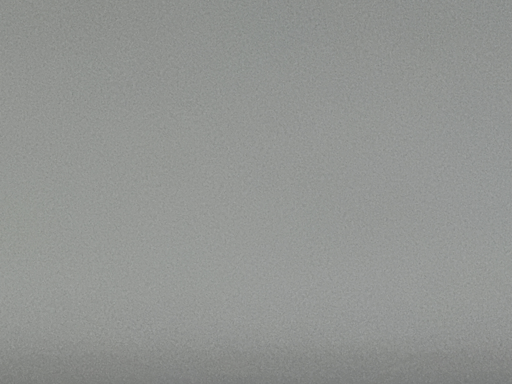 The image is a close-up of a gray, textured surface. There is a subtle gradient of shading with the bottom portion appearing slightly darker. The texture appears granular or speckled. The image does not depict any people, objects, actions, interactions, or identifiable features of Lovech, Bulgaria.