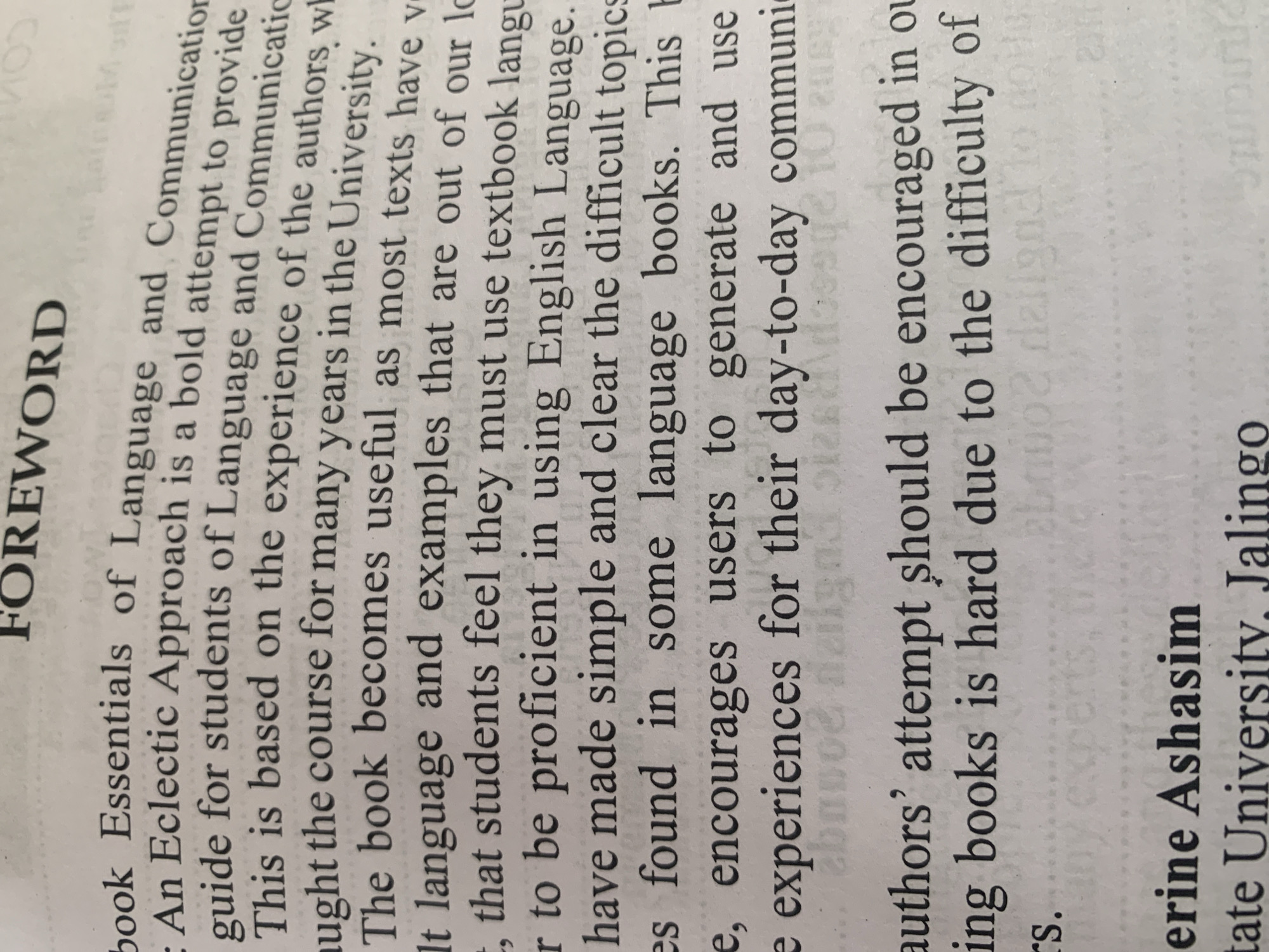 The image is a close-up, top-down shot of a printed page, likely from a book, with the text "FOREWORD" prominently displayed at the top. The text discusses "Essentials of Language and Communication" and refers to a "guide for students." It mentions the authors' experience teaching a university course and the intention to make language and examples useful and clear. The text also talks about the difficulty of writing books and the "day-to-day communication" of users. Towards the bottom, the name "Catherine Ashasim" and "State University, Jalingo" are visible, indicating the author and their affiliation. The background is a white, slightly textured paper. There is no depiction or mention of Jauro Yinu, Nigeria, in the image itself.