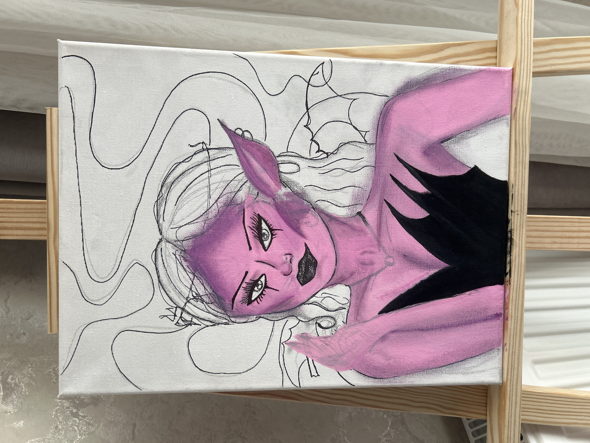 A canvas painting of a purple-skinned woman with elf-like ears is positioned on a wooden easel. The background of the painting is white with a black line drawing of swirling lines. The woman's face is tilted, with noticeable eyelashes and black lipstick. Her body is partially painted pink, with a black section on her chest. The painting appears to be in progress. The location in Tbilisi, Georgia, is not identifiable from the image.